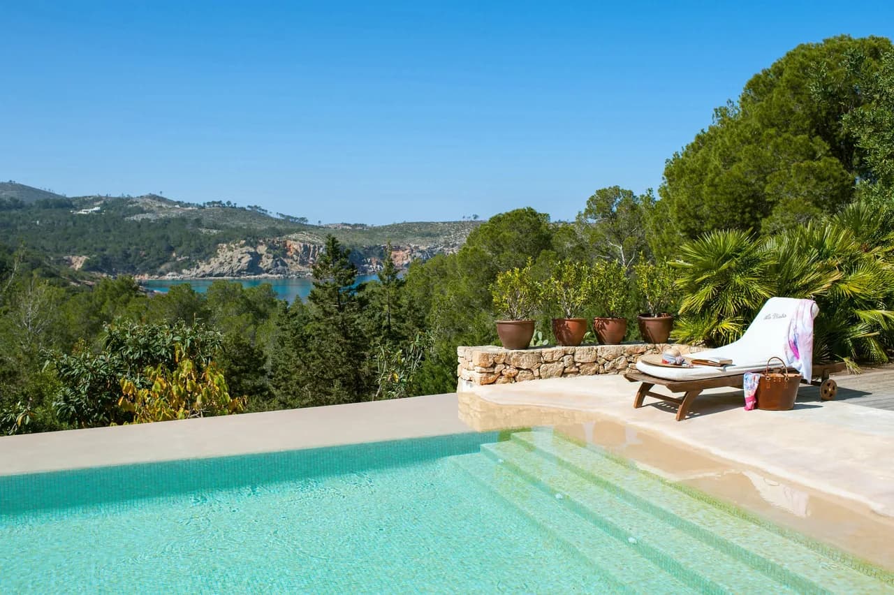 Surrounded by 30 acres of lush pine forest and its own secluded beach cove only a stone's throw away