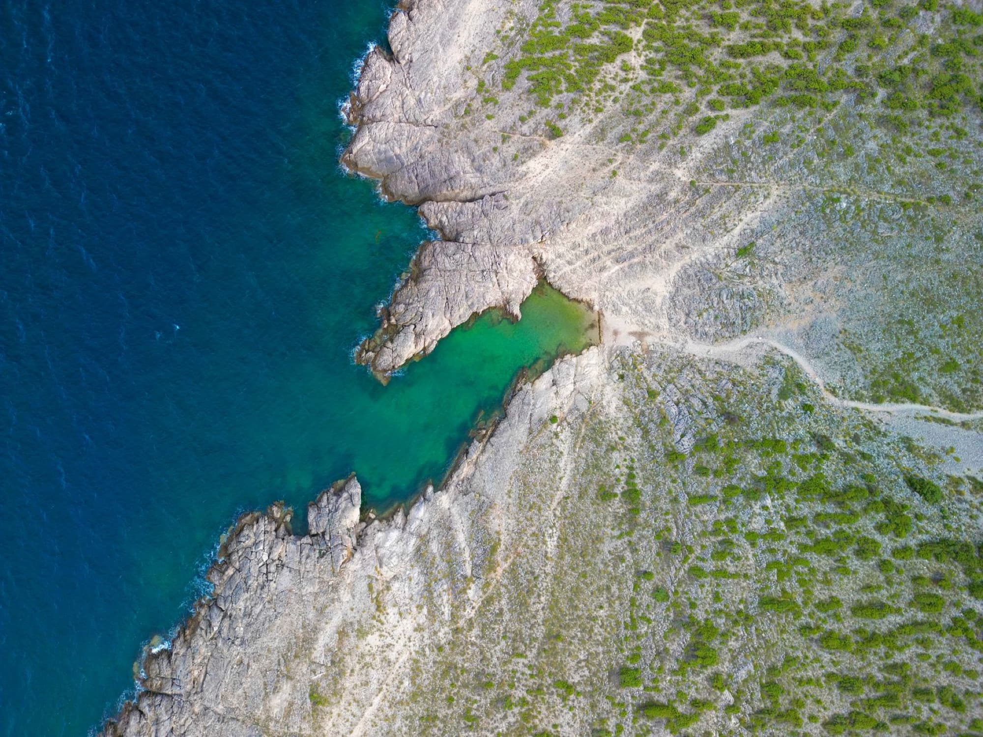 Stunning aerial photography capturing the rocky coastline and turquoise waters of Vrsi, Zadar County, Croatia.