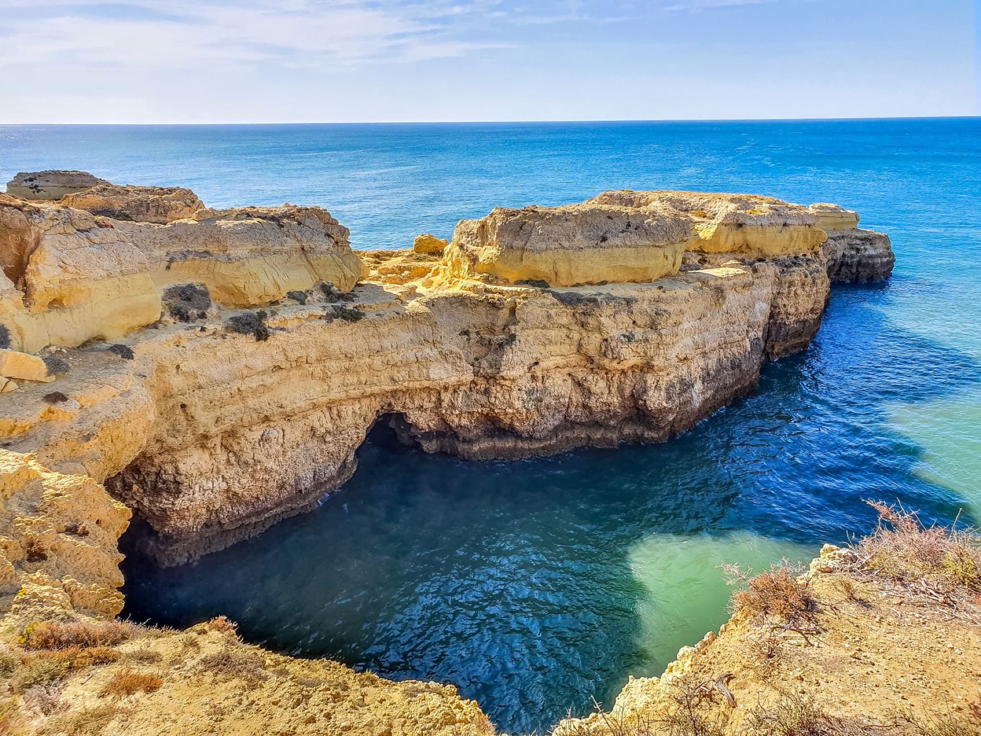Explore the breathtaking cliffs and crystal-clear waters of Algarve, Portugal's scenic coast.