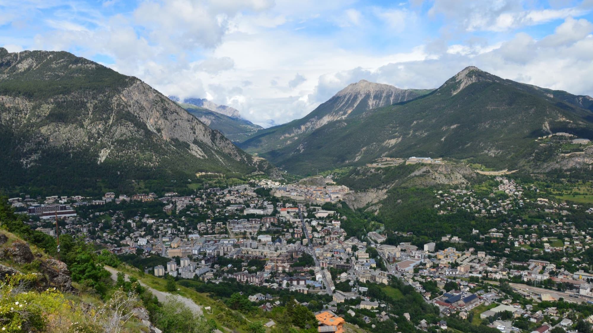 Stunning aerial shot of Puy-Saint-Pierre nestled in the French Alps, showcasing the town and mountains.