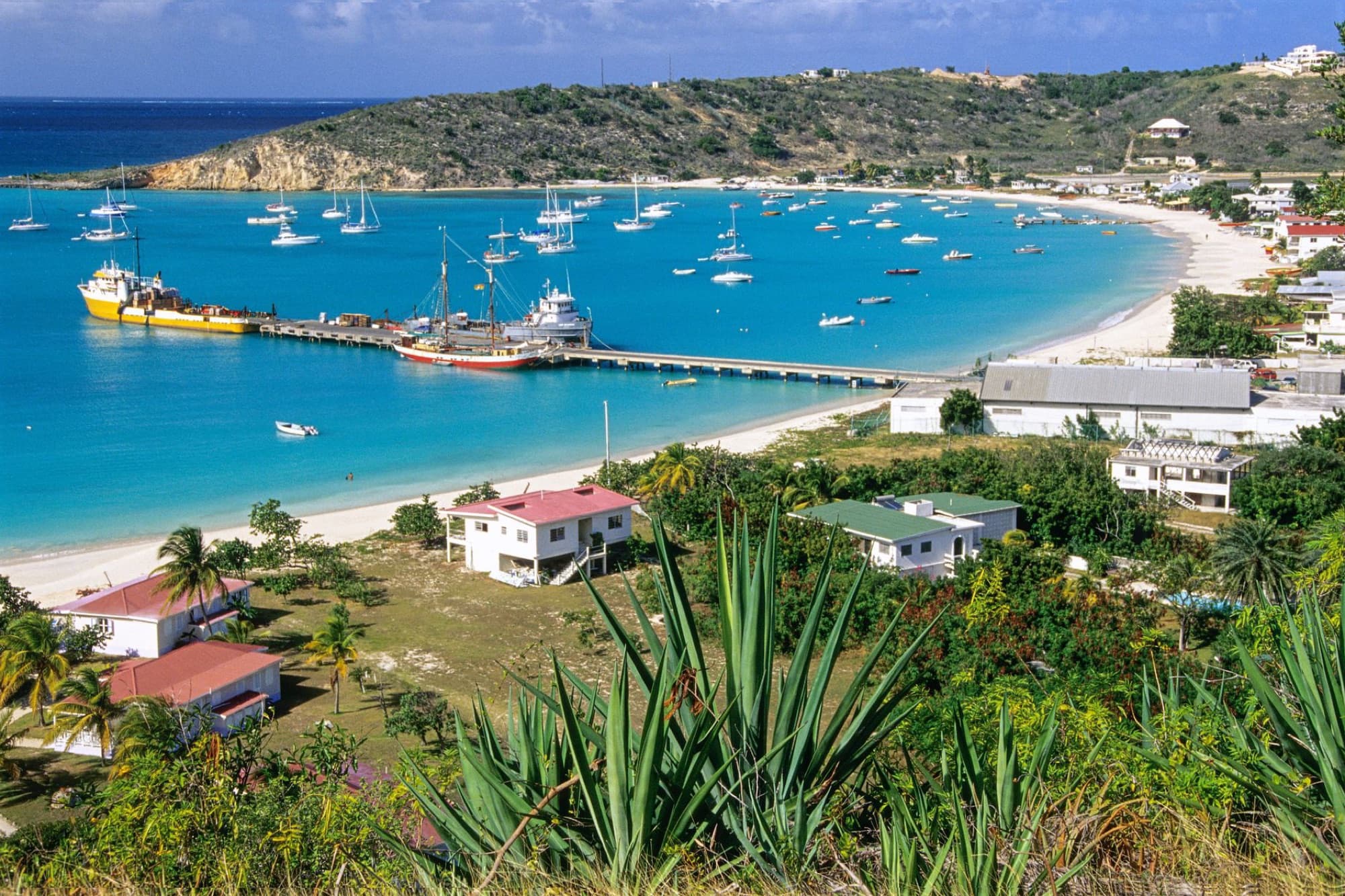 Stunning aerial view of Sandy Ground Bay in Anguilla with boats and turquoise waters.