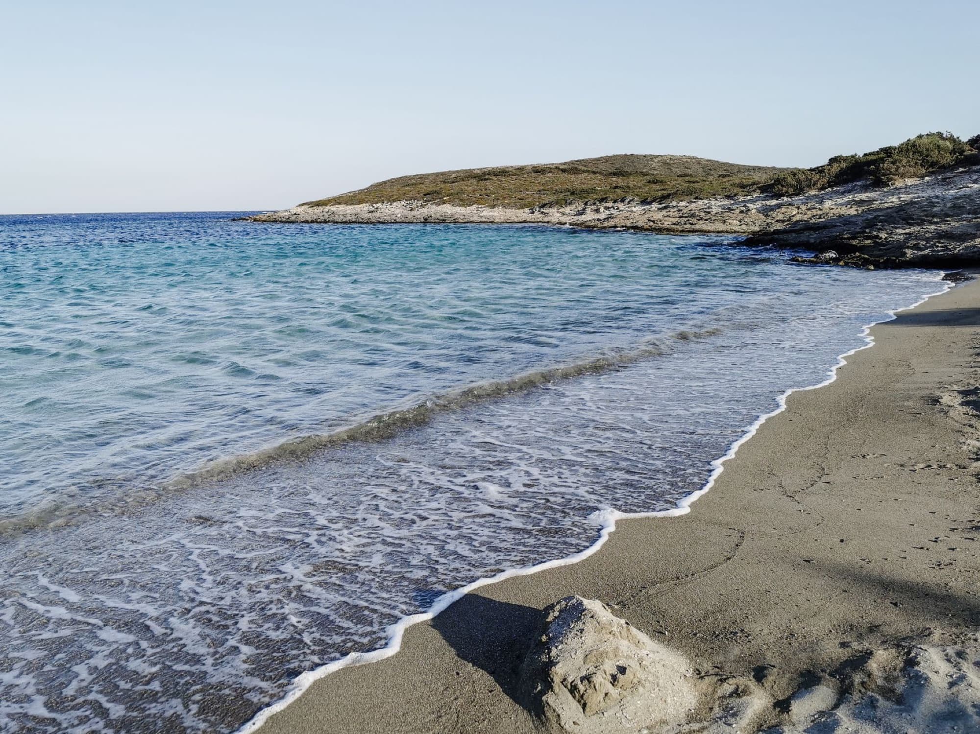Peaceful beach scene on Antiparos Island with turquoise waters and sandy shore, perfect for a summer getaway.