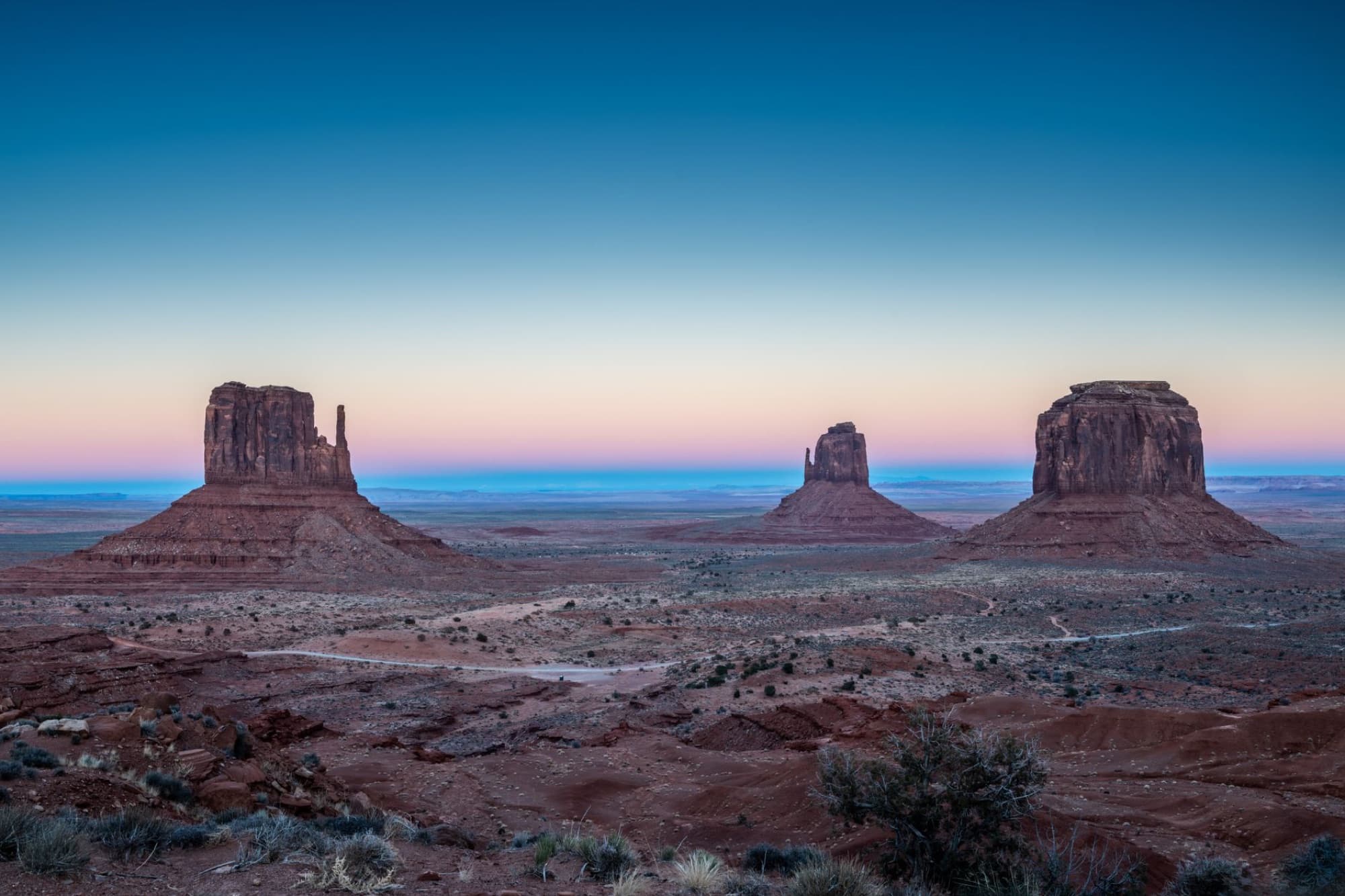 Breathtaking sunrise over Monument Valley's famous buttes in Arizona, capturing a serene desert landscape.