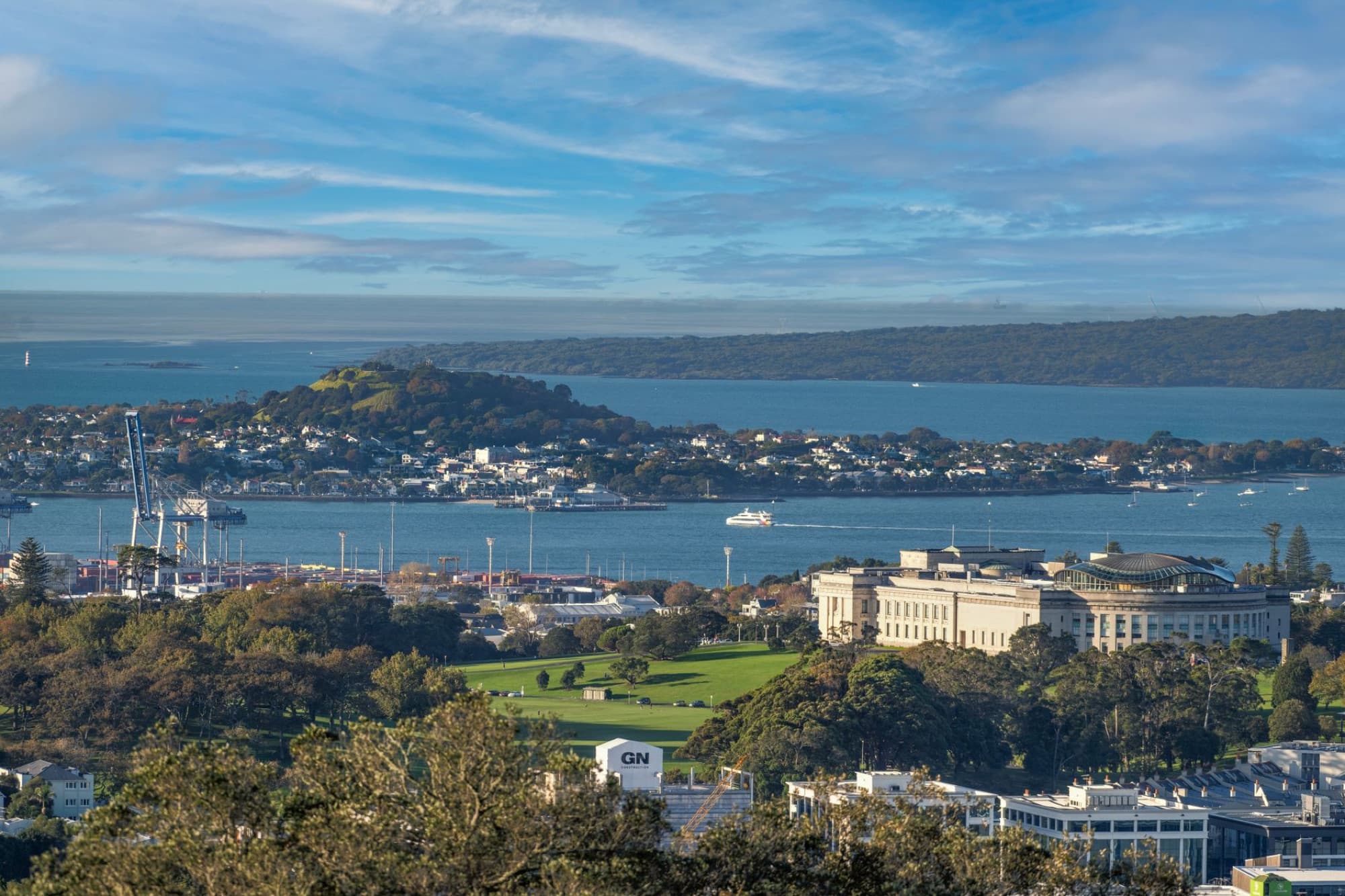 Scenic view of Auckland Museum, harbor, and city skyline on a clear day.