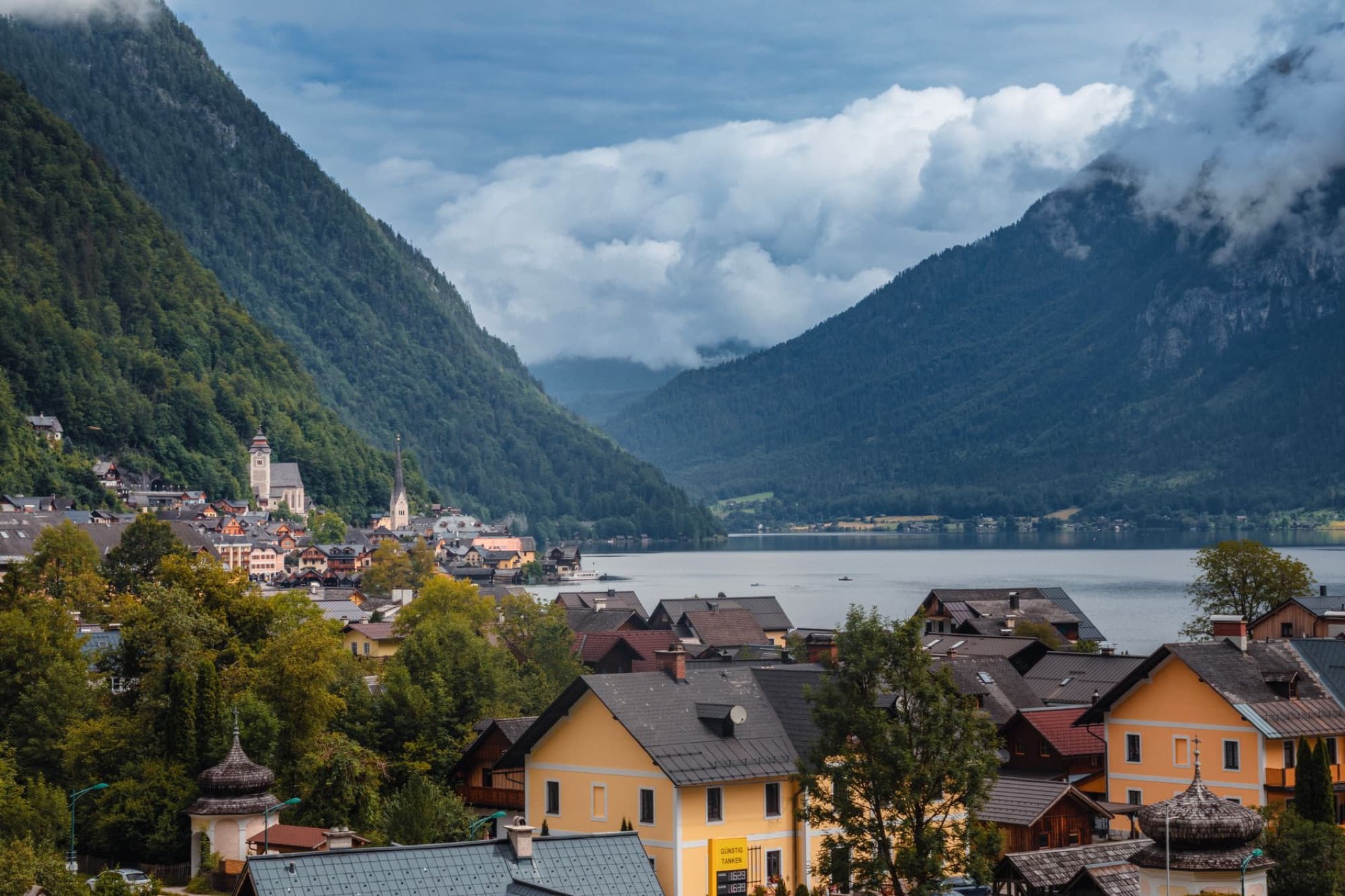 A scenic view of Hallstatt, Austria, with lush mountains and serene lake.