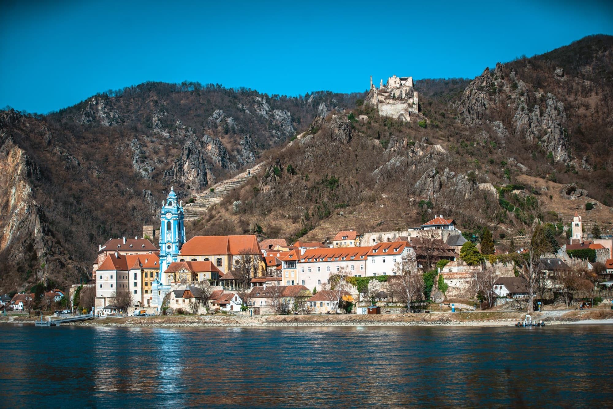 Scenic view of Dürnstein Abbey and Castle against rocky hills in Wachau Valley, Austria.