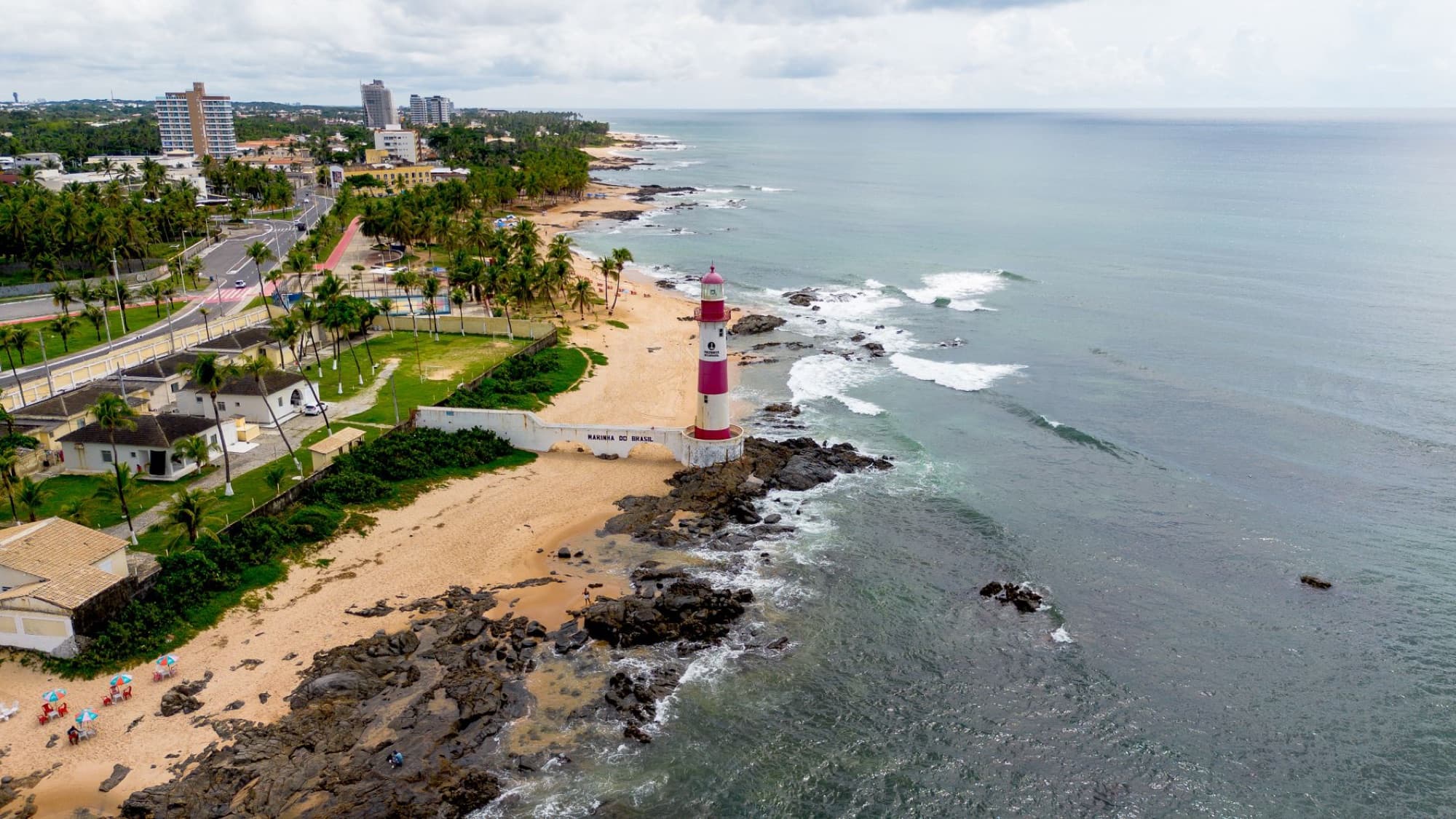 Scenic aerial shot of Farol de Itapua lighthouse on the coast of Salvador, Bahia, Brazil.