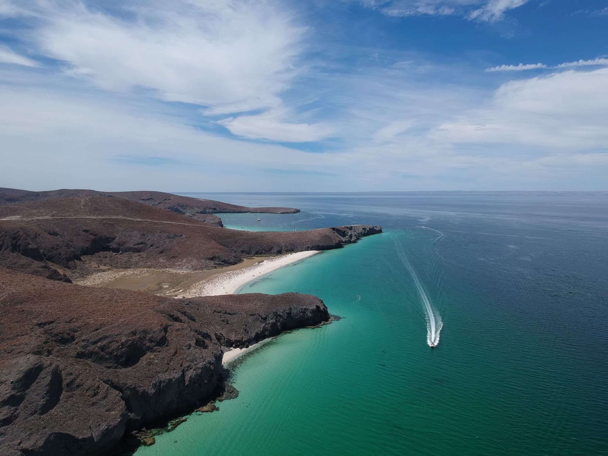 A stunning aerial view of the coastline in Baja California Sur, Mexico, showcasing cliffs and turquoise waters.