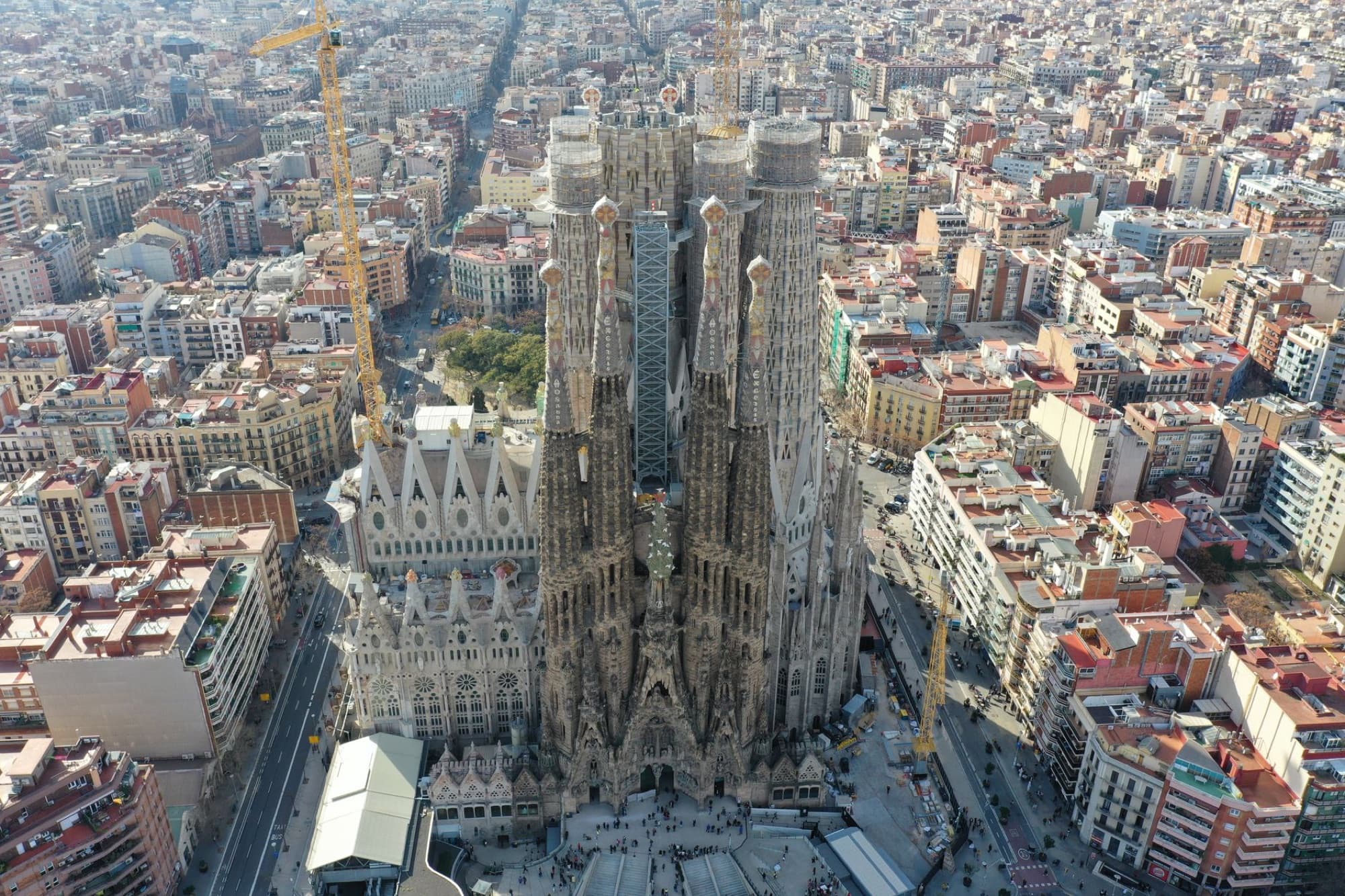 Stunning aerial shot of the iconic Sagrada Familia cathedral in Barcelona, showcasing its intricate architecture and surrounding urban landscape.