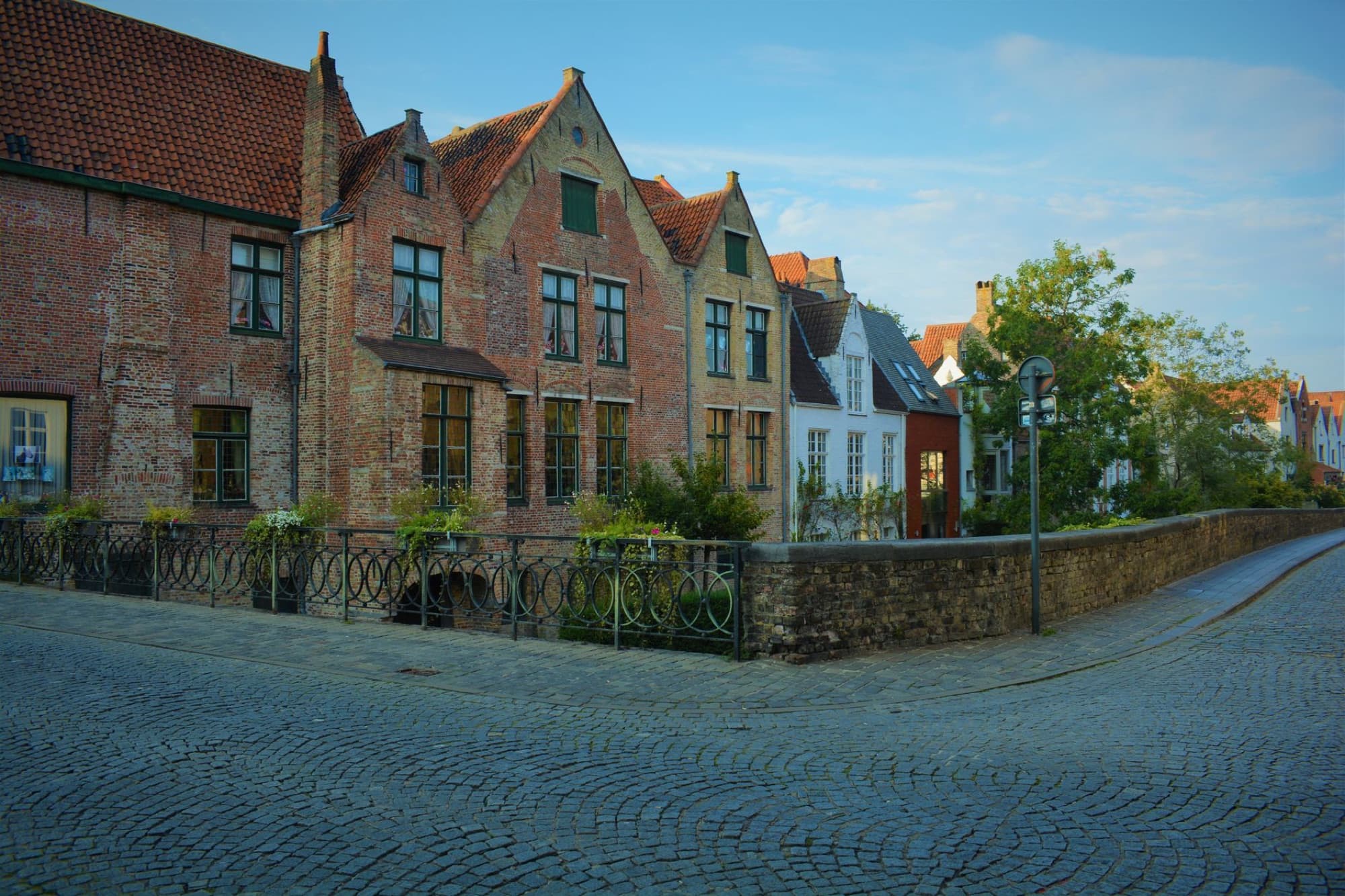 Picturesque view of medieval houses lining a cobblestone street in Bruges, Belgium.
