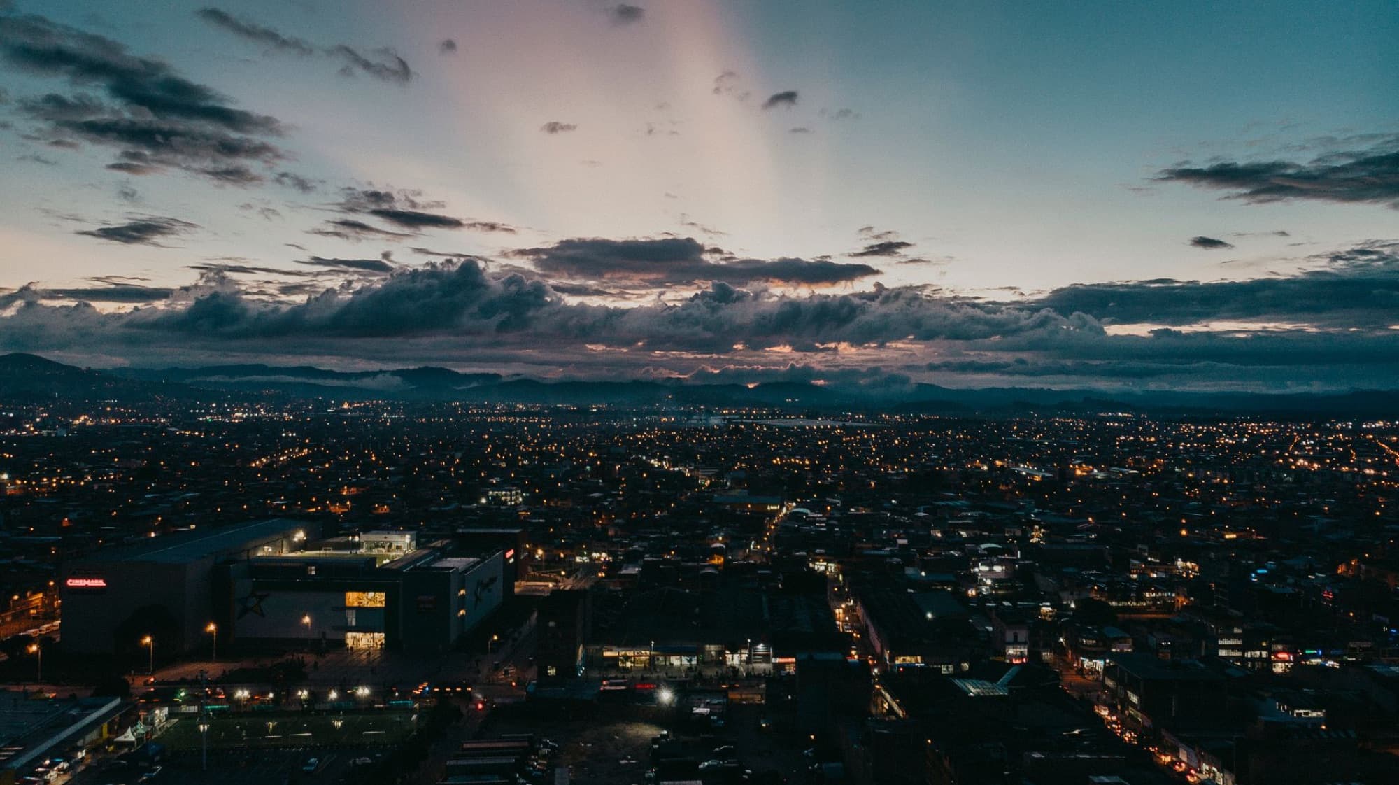 Captivating aerial view of Bogotá's skyline at sunset, showcasing a vibrant urban scene.