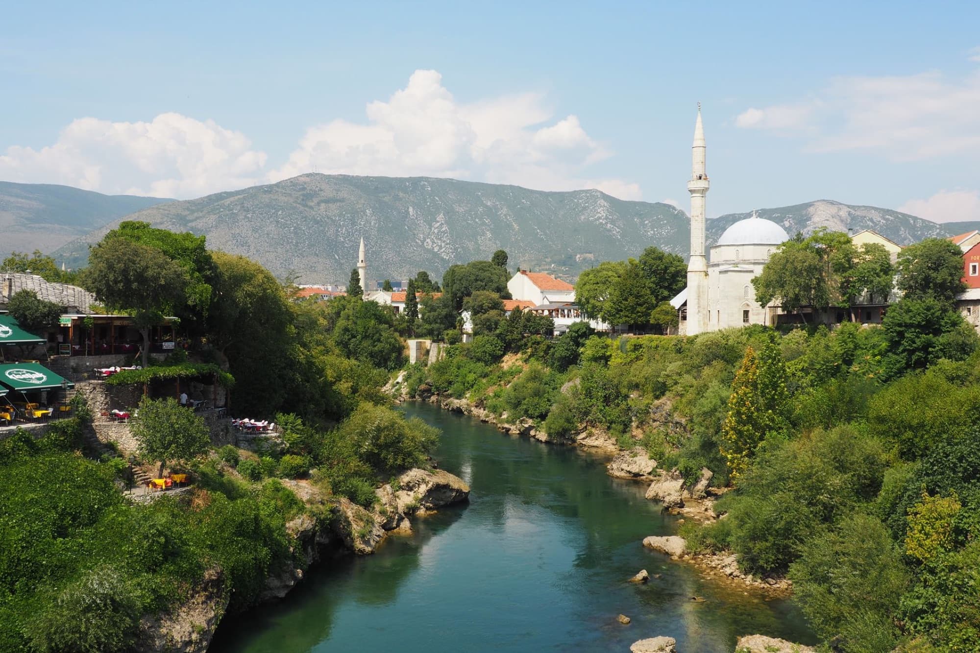 Stunning aerial view of Neretva River with the historic Koski Mehmed Pasha Mosque in Mostar, Bosnia and Herzegovina.