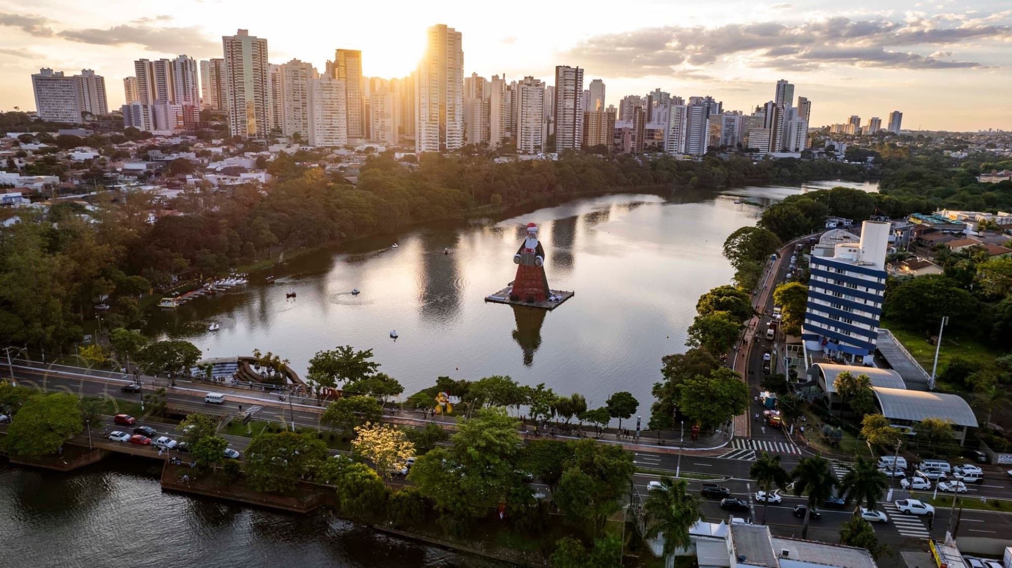 Stunning aerial view of Lago Igapó in Londrina, Brazil, with city skyline at sunset.