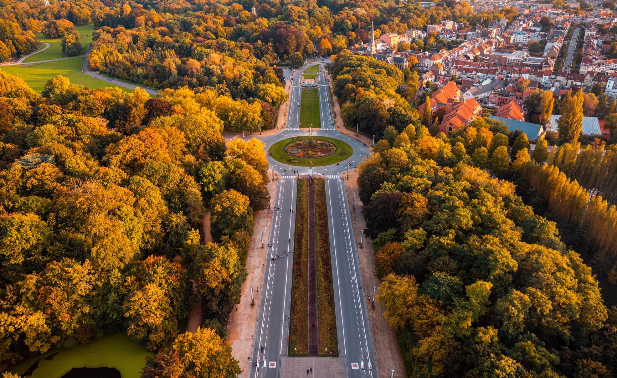 Breathtaking aerial view of Heysel Park, Brussels during autumn showcasing vibrant foliage and cityscape.