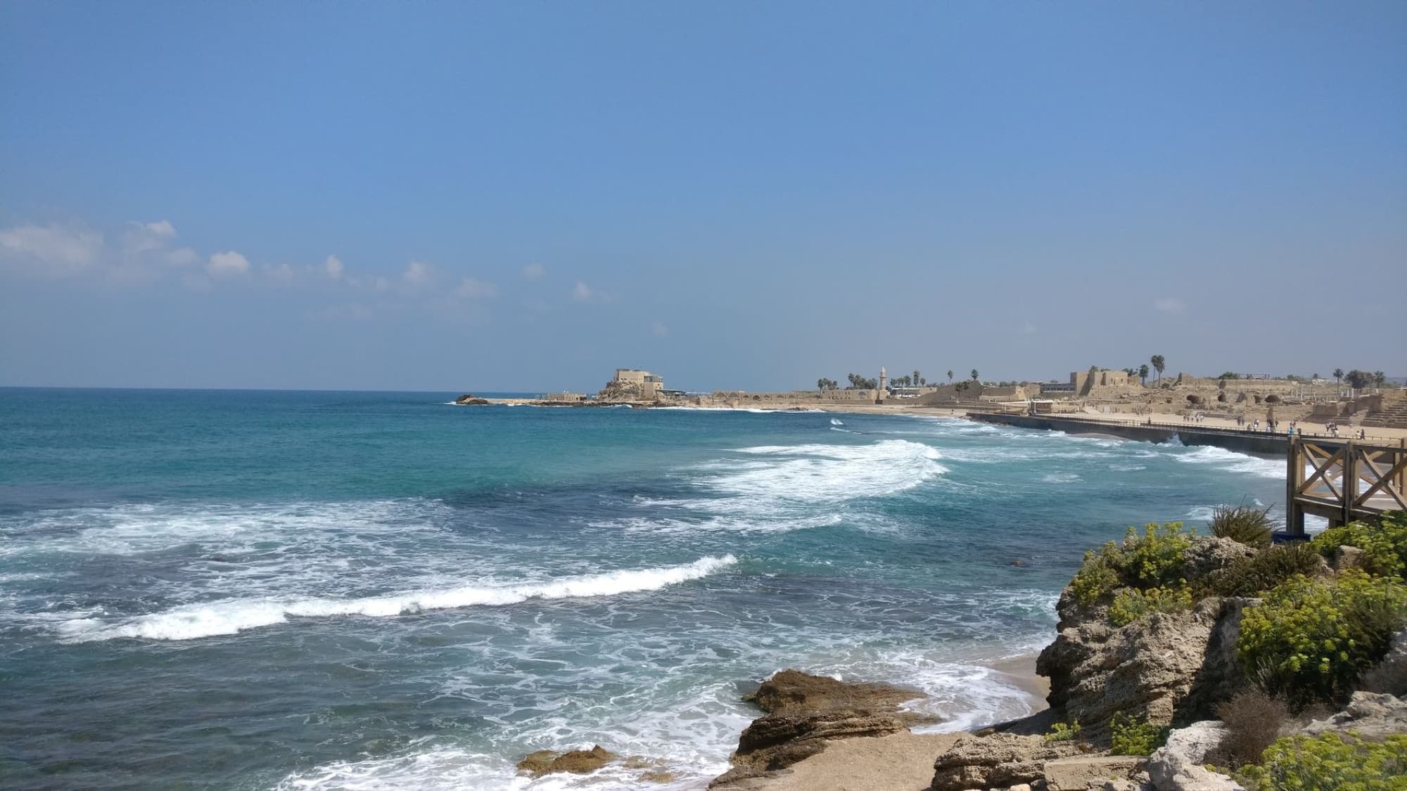 Explore the ancient coastal ruins of Caesarea with stunning Mediterranean views and waves crashing on the shore.
