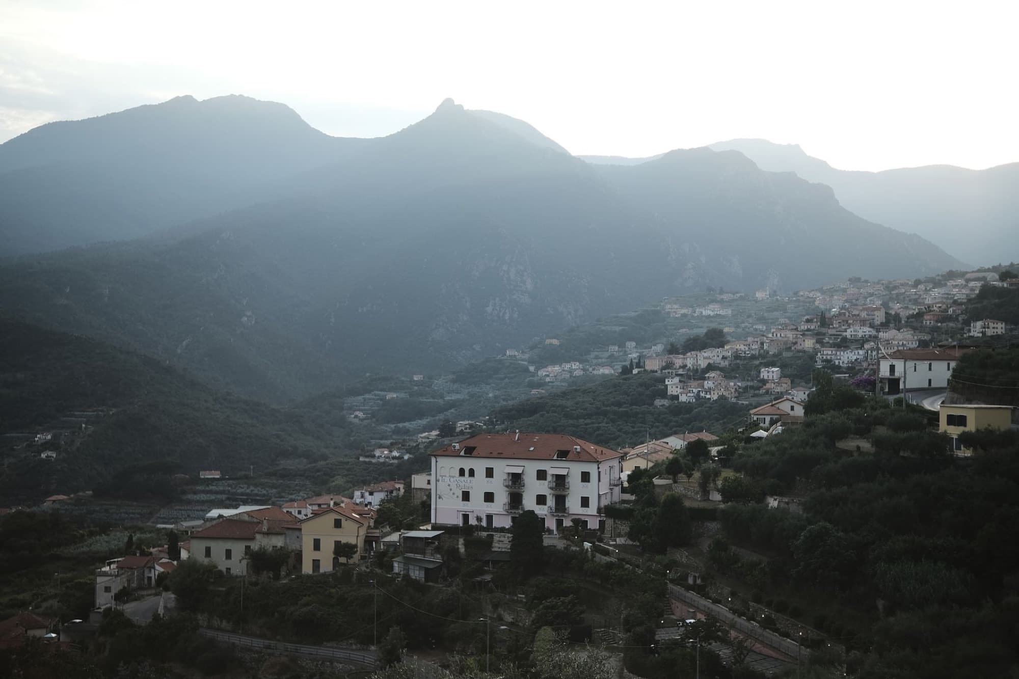Scenic view of a mountain village in Italy during daytime, capturing the serene landscape.