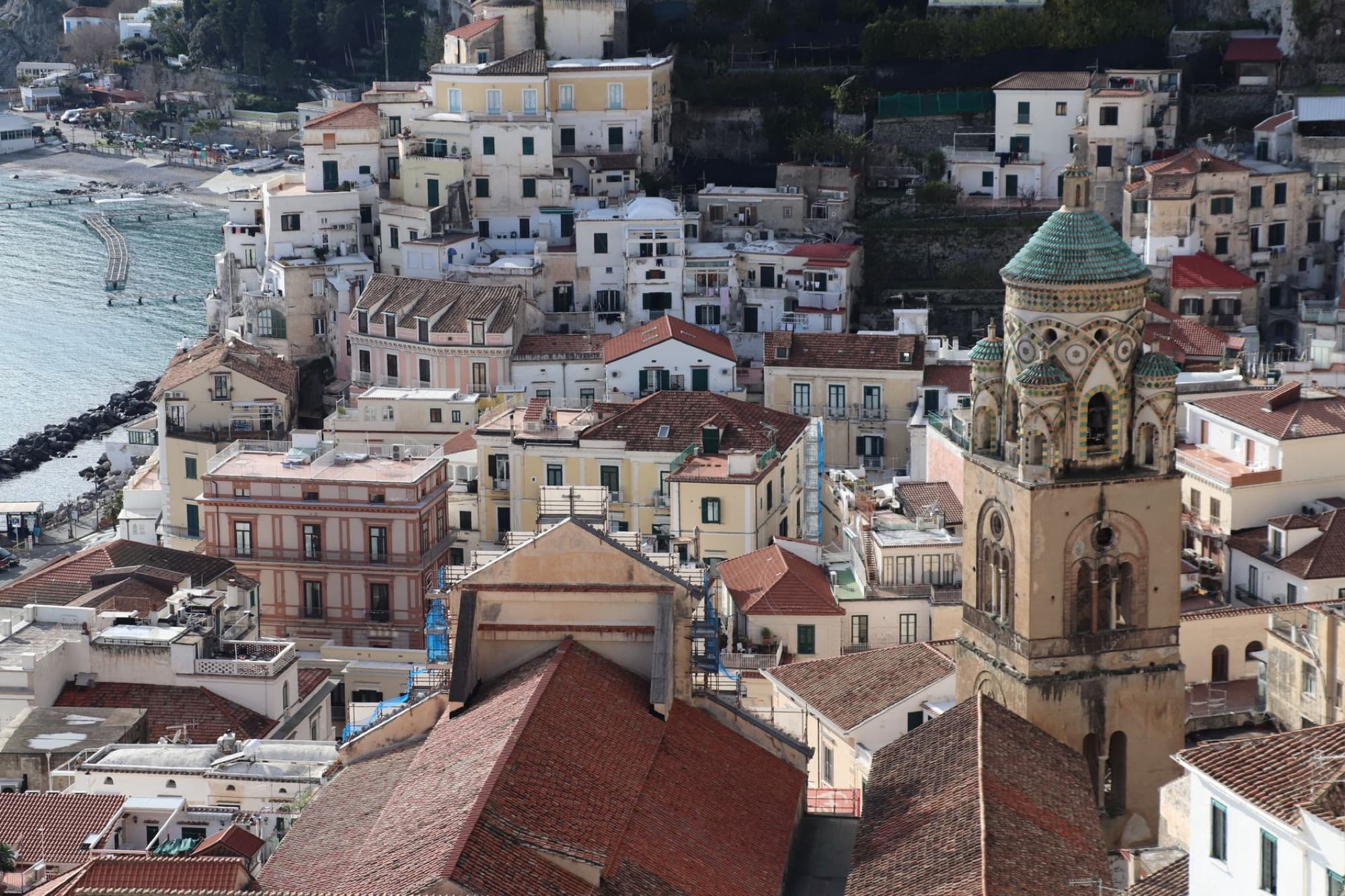 Aerial shot of a quaint coastal town with historic architecture and scenic waterfront.