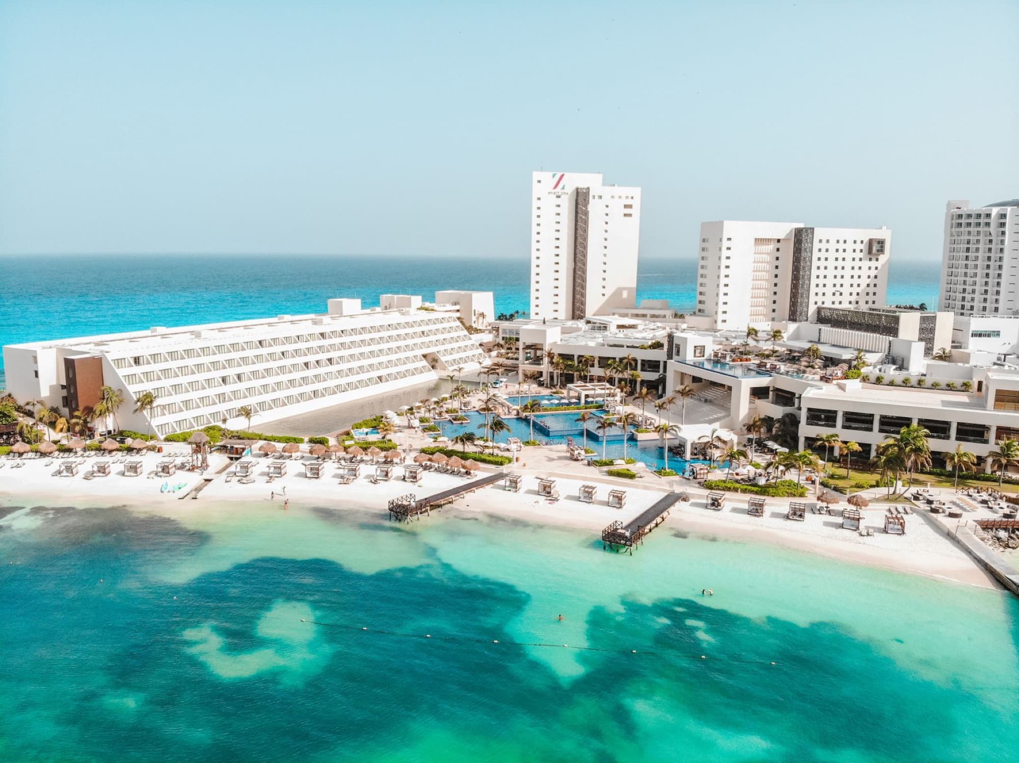 Stunning aerial view of Cancun beach resort, showcasing blue waters and sunny skies, ideal for a summer vacation.