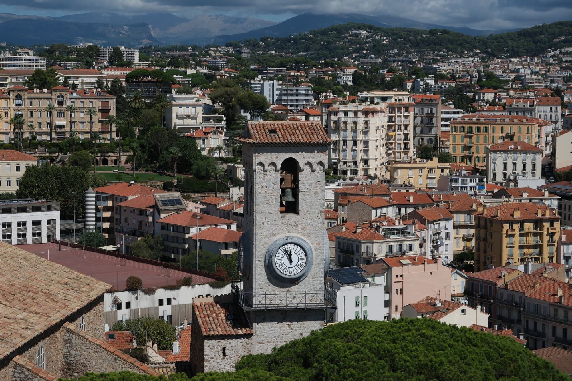A stunning aerial view of the iconic clock tower amidst the vibrant cityscape of Cannes, France.