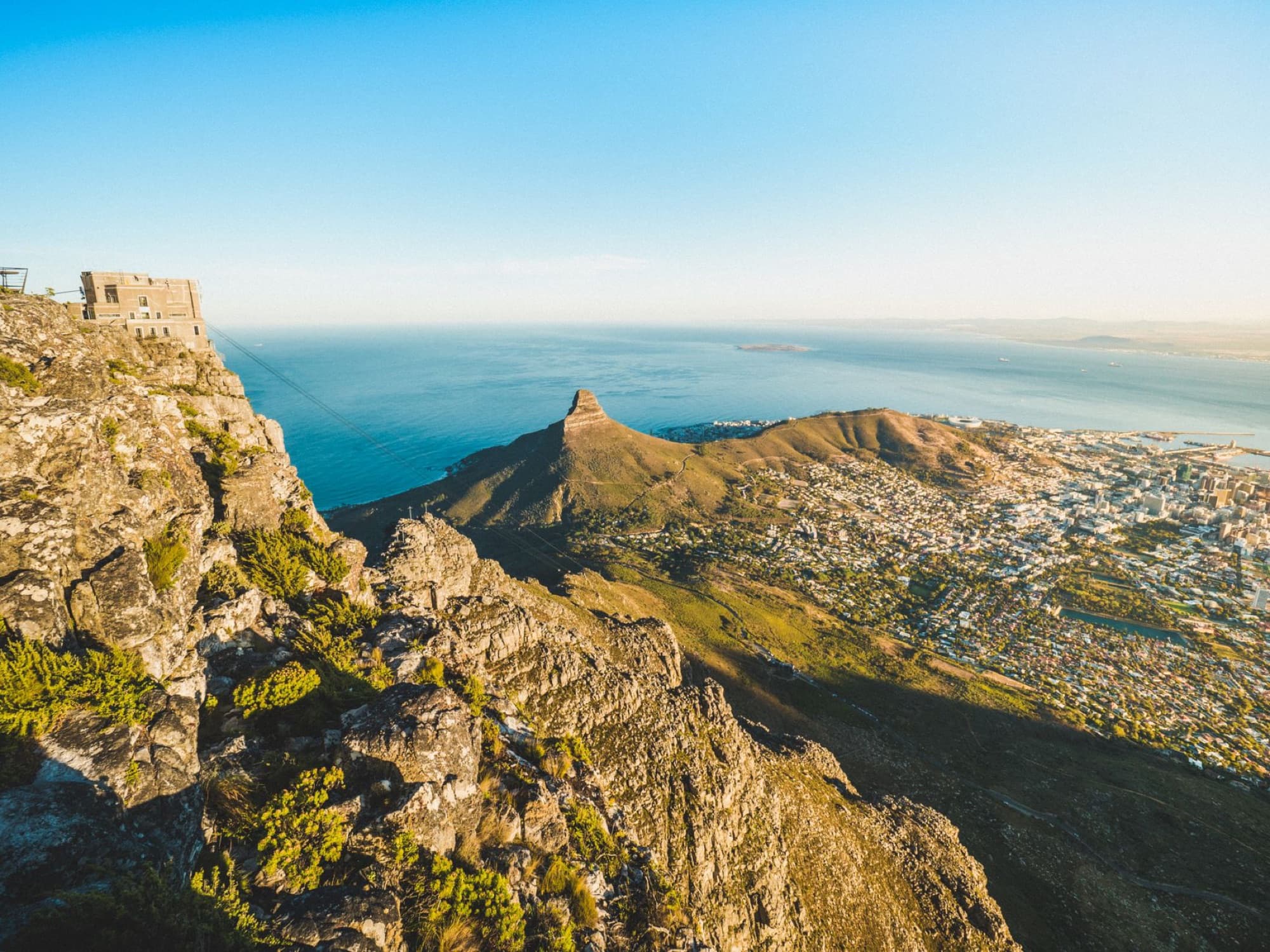 A breathtaking aerial view showcasing Table Mountain and Lion's Head overlooking Cape Town's coastline.