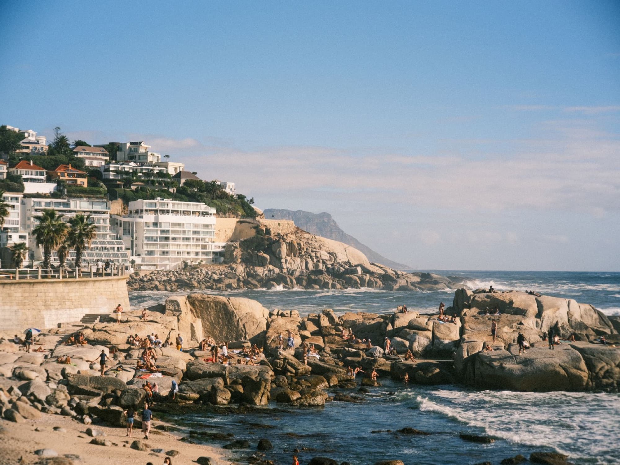 Beautiful coastal view of Camps Bay Beach with lush cliffs and ocean in Cape Town, South Africa.