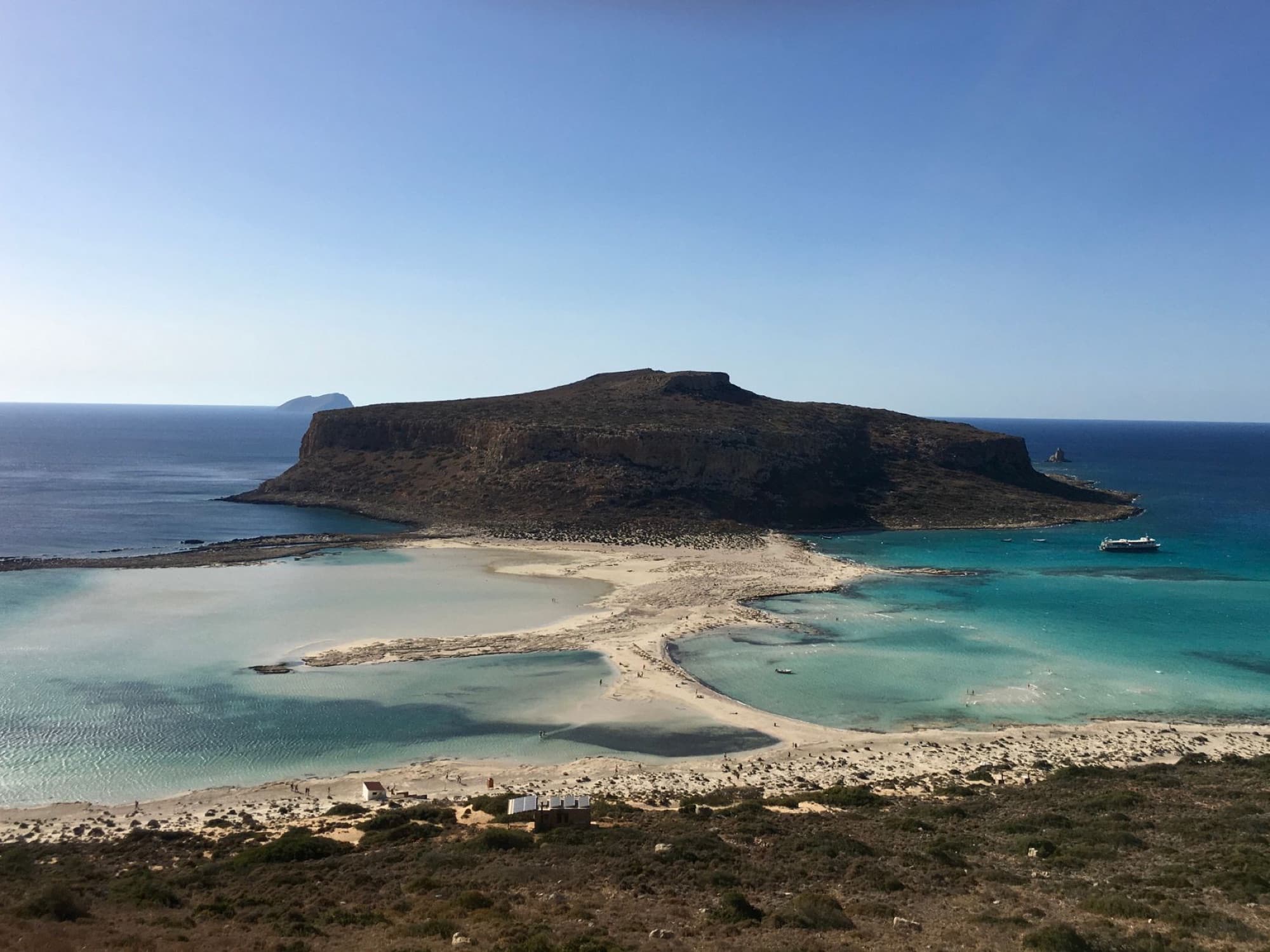 A beautiful aerial shot of Balos Lagoon in Chania, Greece capturing the clear turquoise waters and scenic coastline.