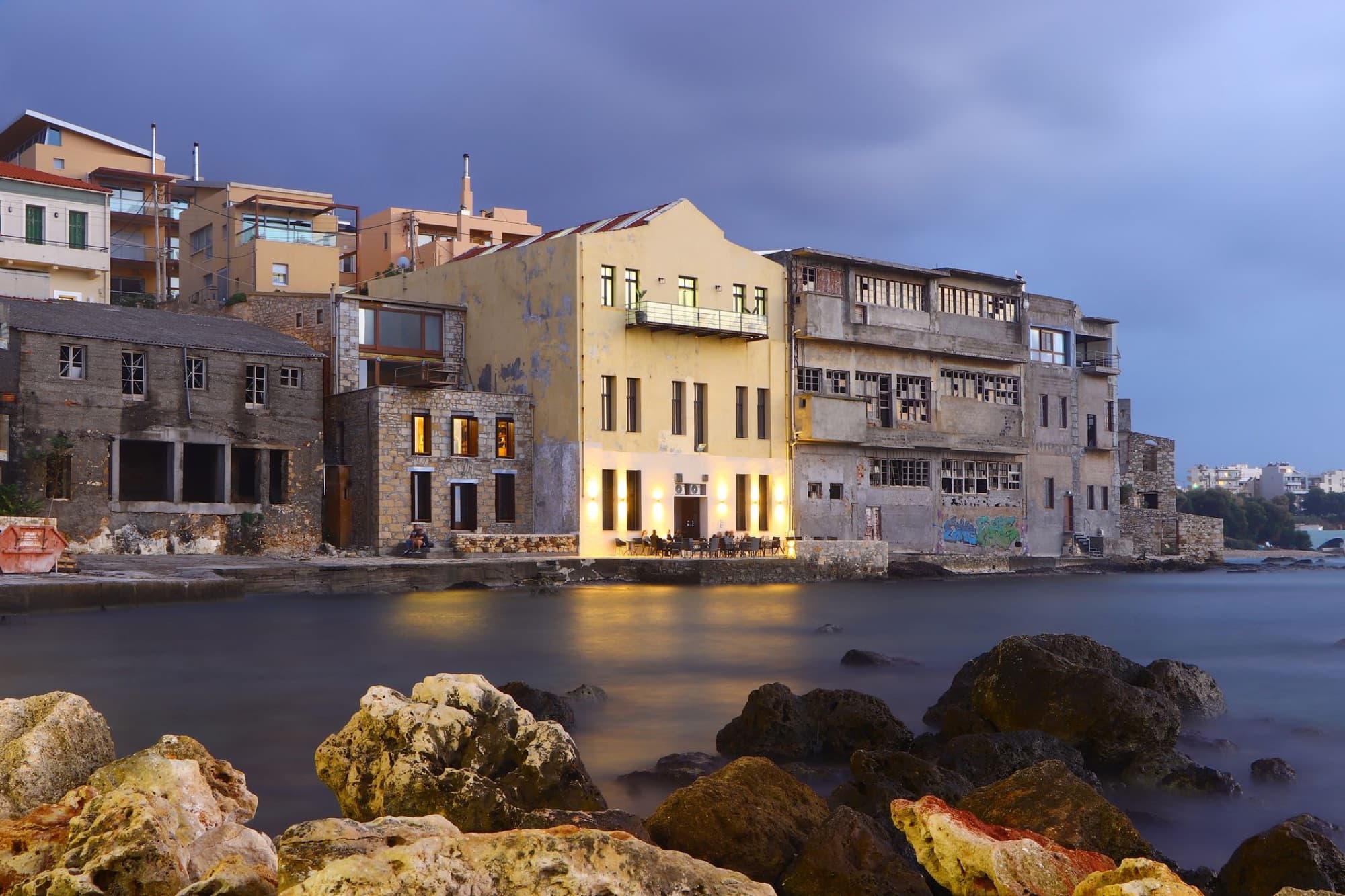 Scenic view of old buildings along the coast at dusk in Chania, Greece.