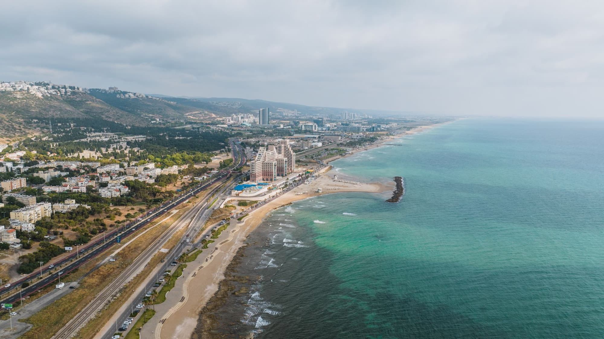 Stunning aerial view of Haifa's coastline and urban landscape on a clear day.