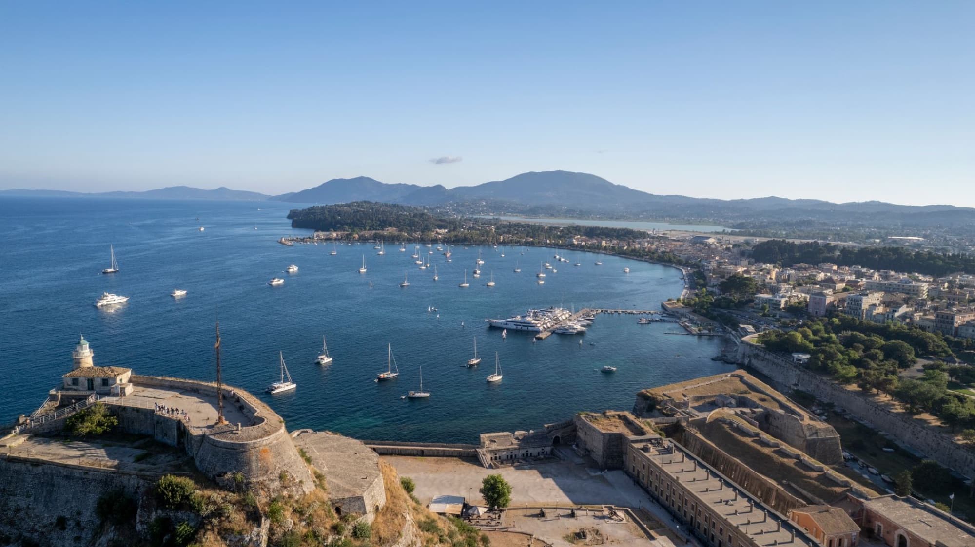 Scenic aerial view of the Old Fortress overlooking the bay with sailboats in Corfu, Greece.