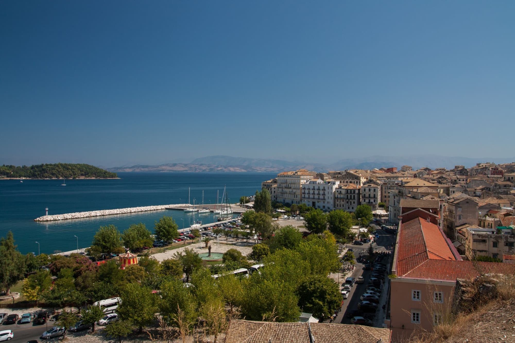 Beautiful aerial view of Corfu's old town and harbor with clear blue skies.