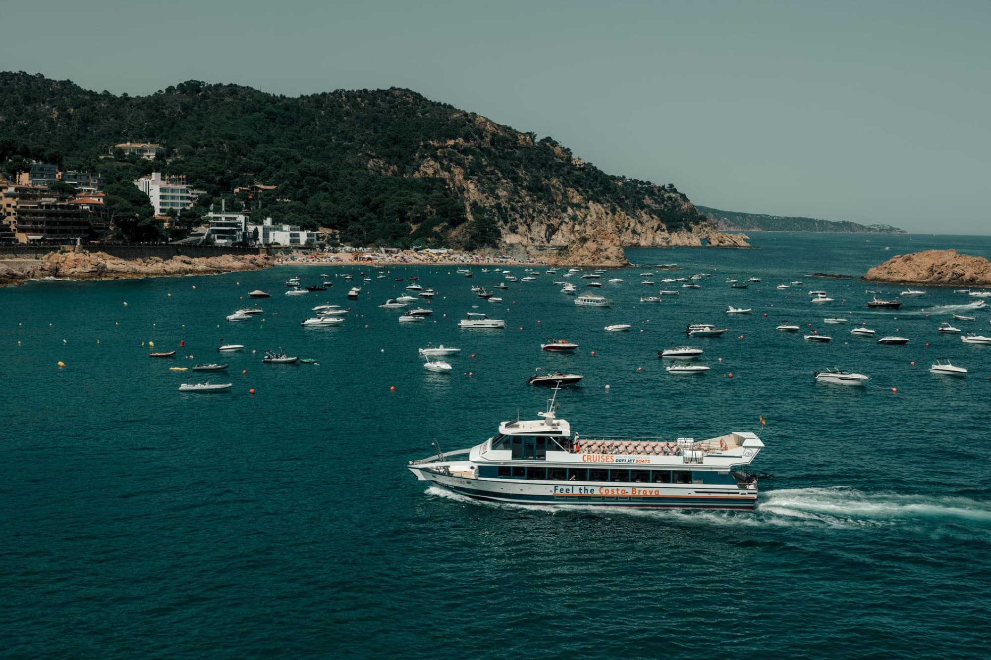 Explore the stunning coastline and vibrant sea life on a boat tour in Tossa de Mar, Costa Brava.
