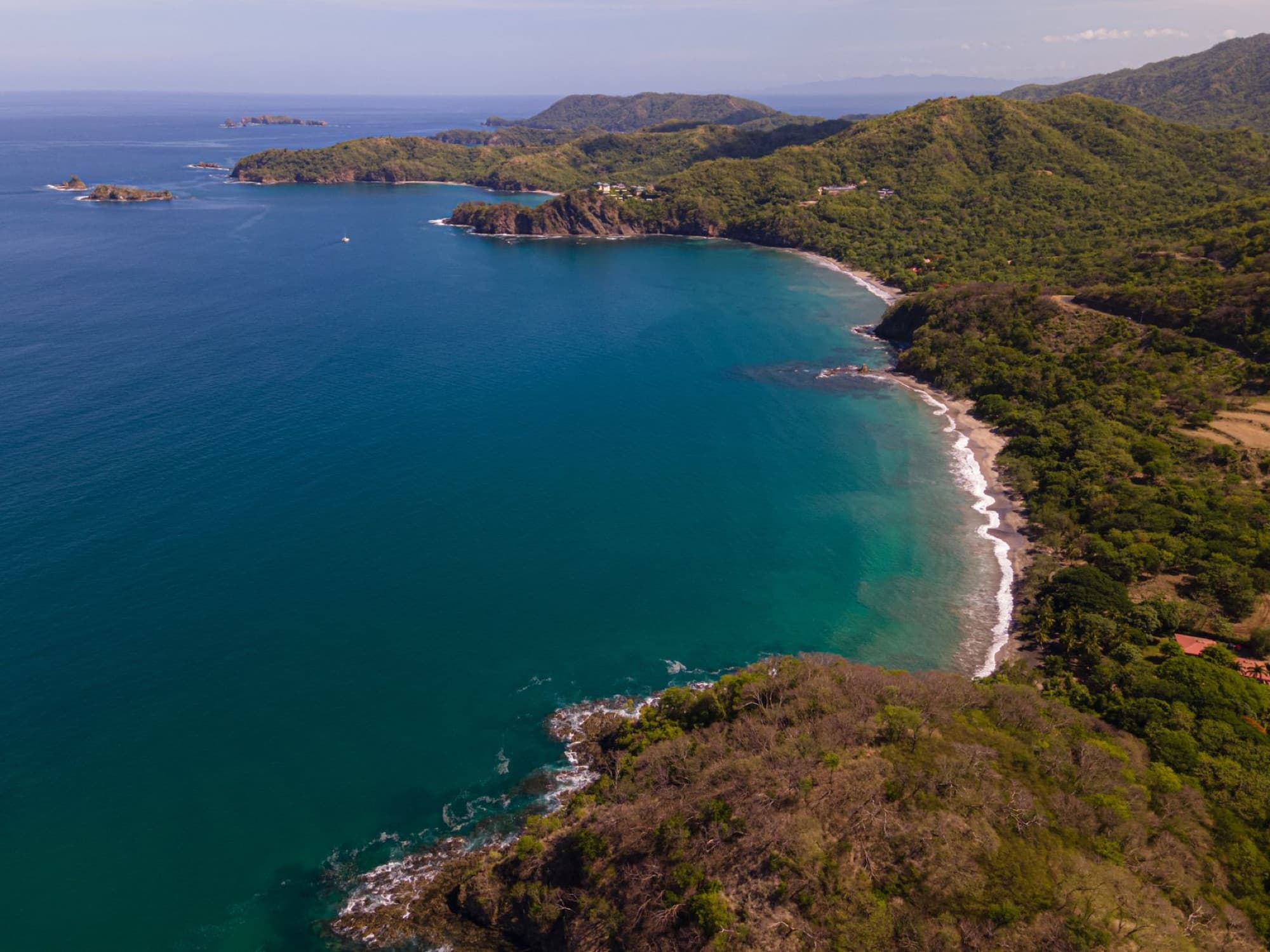 A breathtaking aerial view of the lush coastline and blue waters in Guanacaste, Costa Rica.