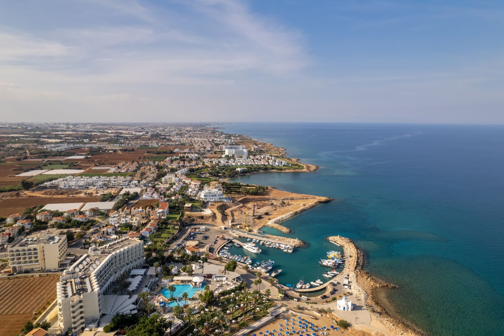Stunning aerial view of Protaras Bay with hotels, coastline, and azure Mediterranean sea in Cyprus.