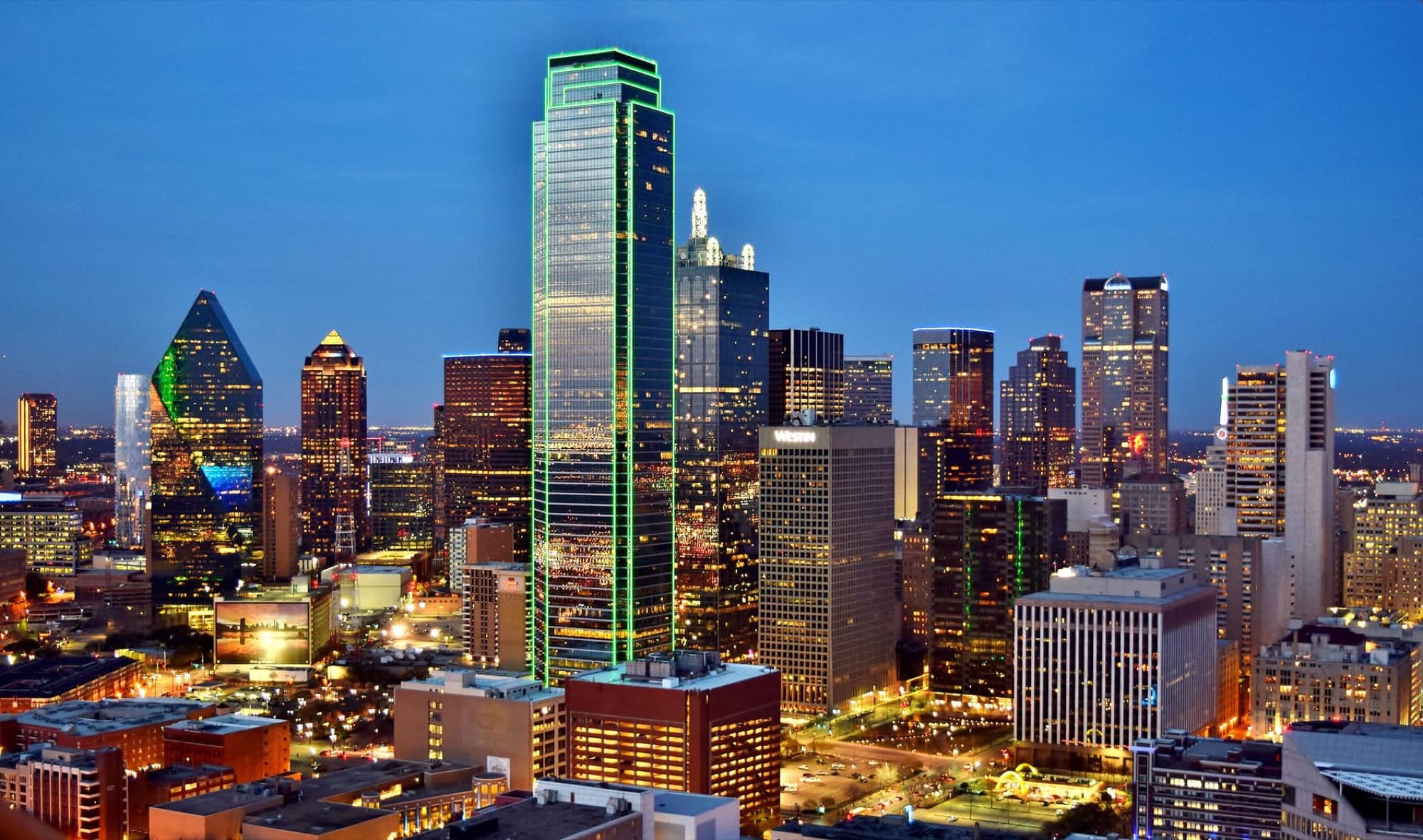 Stunning view of the Dallas skyline at night with illuminated skyscrapers and city lights.