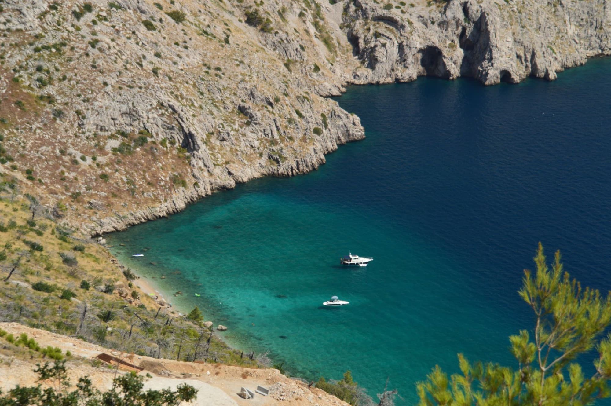 A breathtaking aerial view of the Croatian coast with turquoise waters and rocky cliffs.