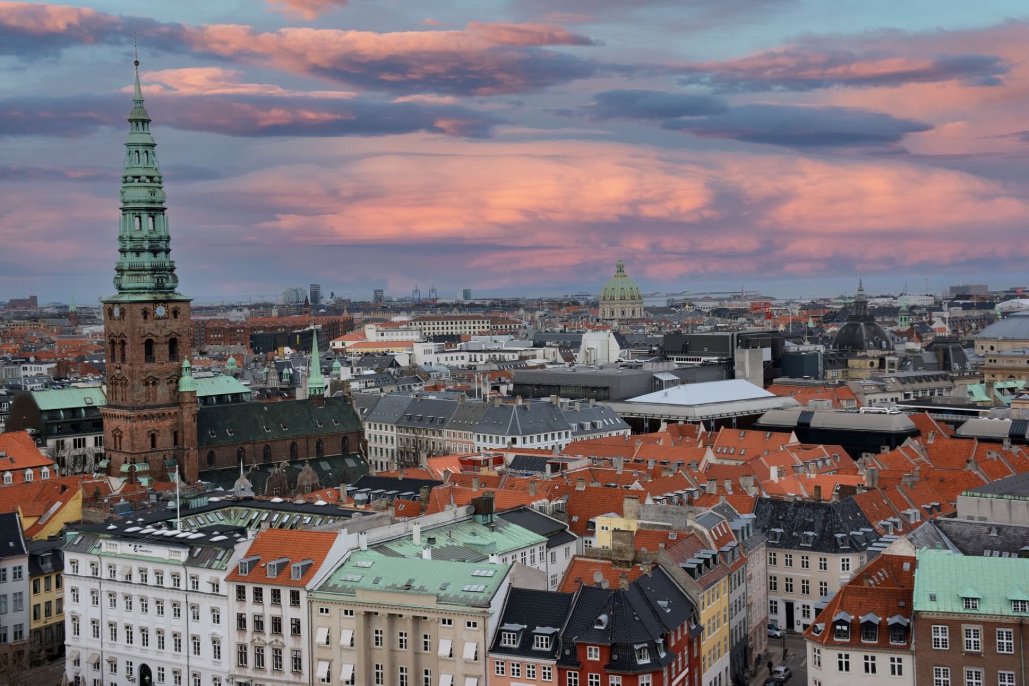A picturesque aerial view of Copenhagen, Denmark with vibrant sunset skies.