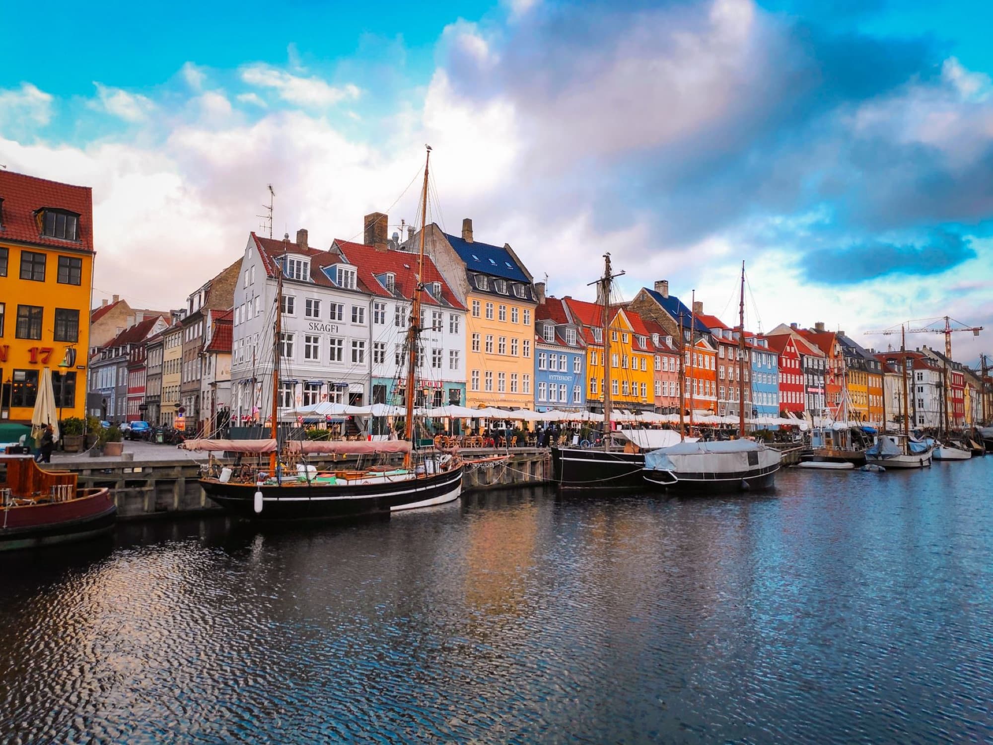 Colorful buildings and boats line the Nyhavn harbor in Copenhagen, Denmark.