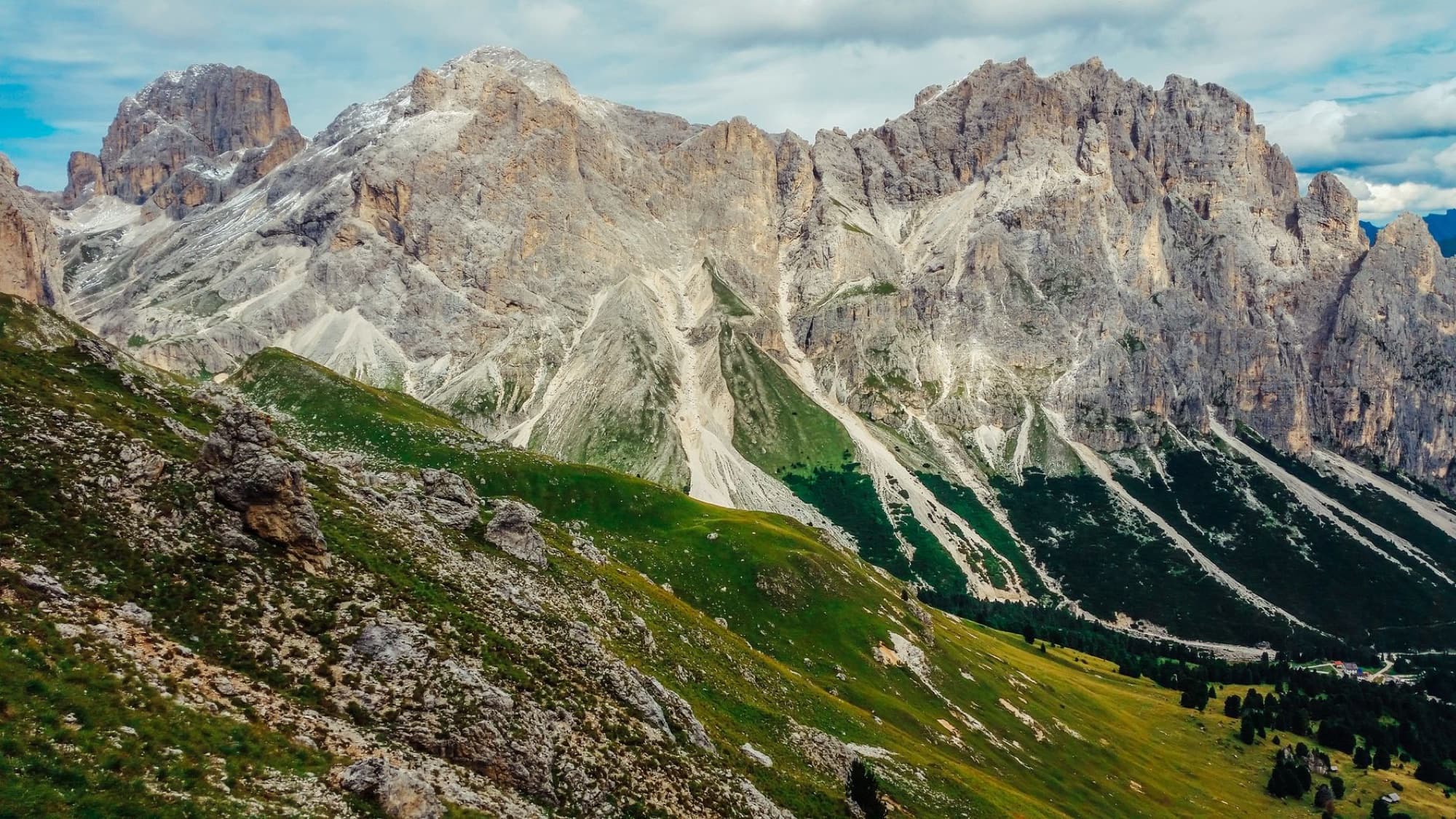 Breathtaking mountain landscape in the Dolomites, showcasing prominent rocky peaks and green valleys.