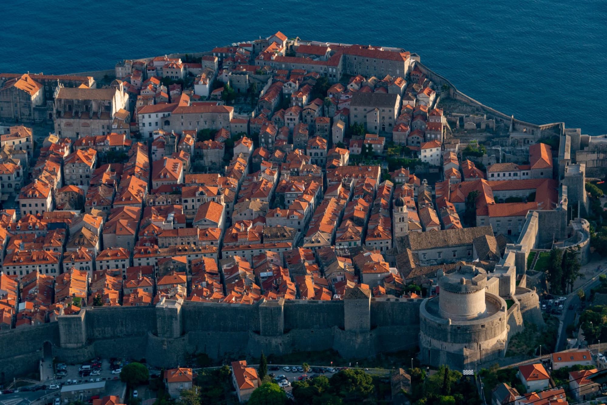 Breathtaking aerial shot of Dubrovnik's historic Old Town, showcasing ancient city walls and red-tiled roofs.