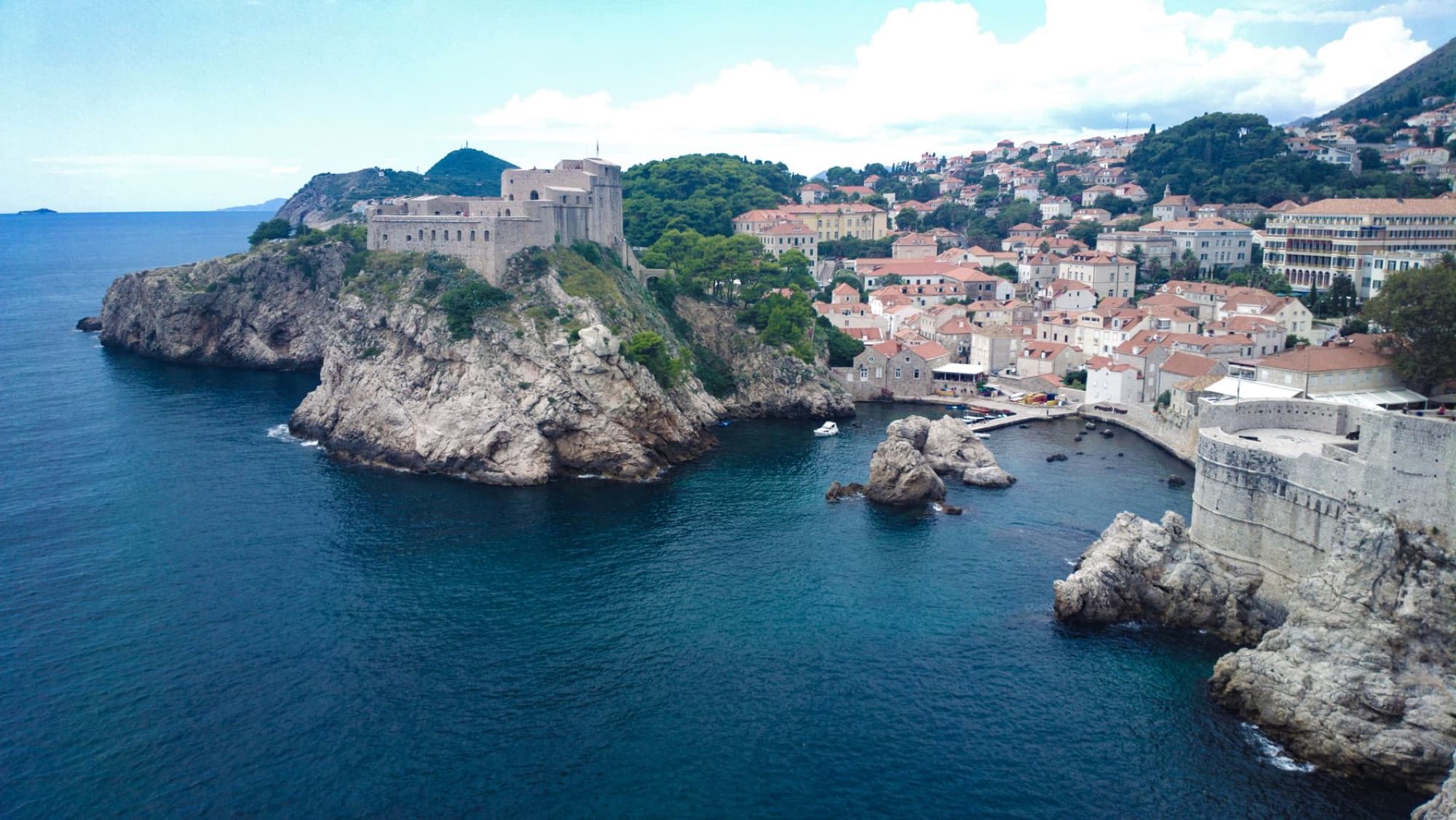 Scenic aerial view of Dubrovnik's rugged coastline and historic architecture.