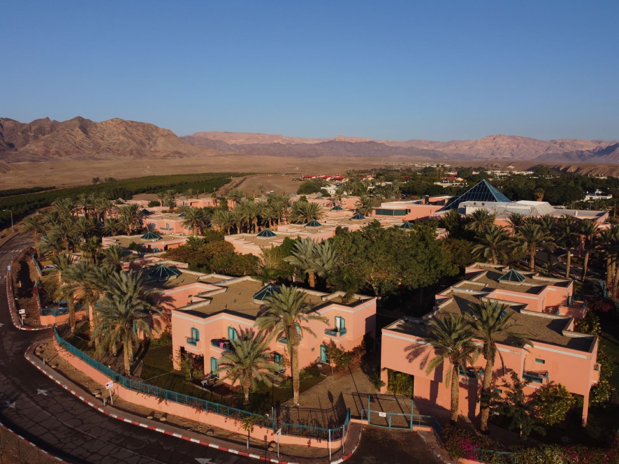 Aerial view of U Splash Resort in Eilat, Israel, amidst palm trees and desert landscape.