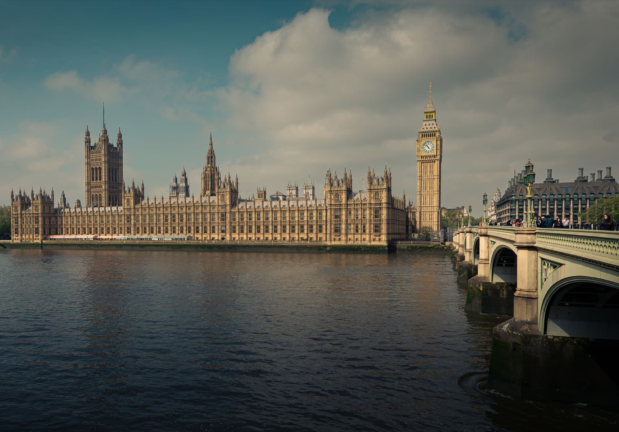 A stunning view of the Houses of Parliament and Big Ben alongside the River Thames in London, England.