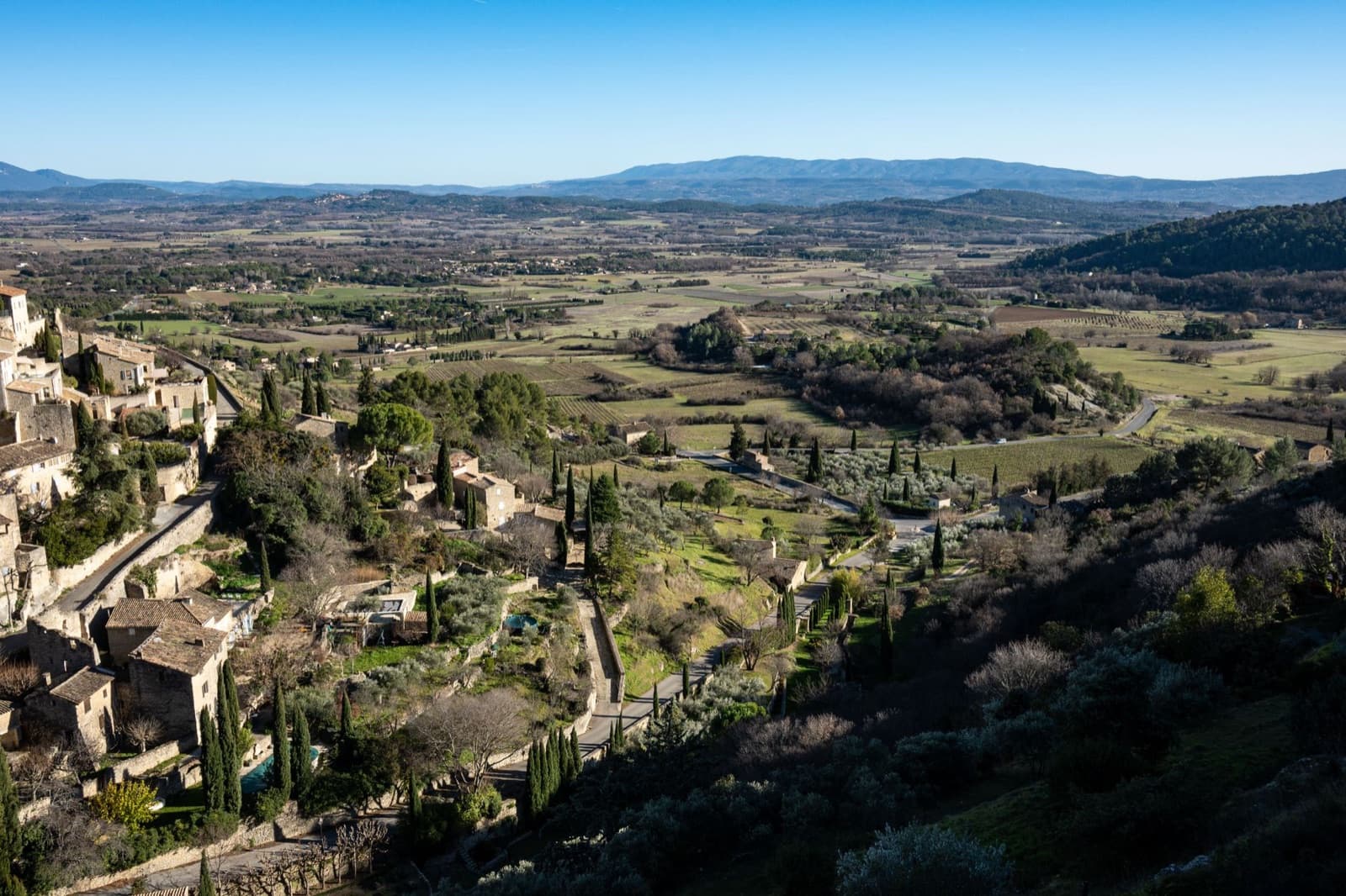 Aerial view of Gordes, a beautiful village in Provence, France with lush landscapes and historic architecture.