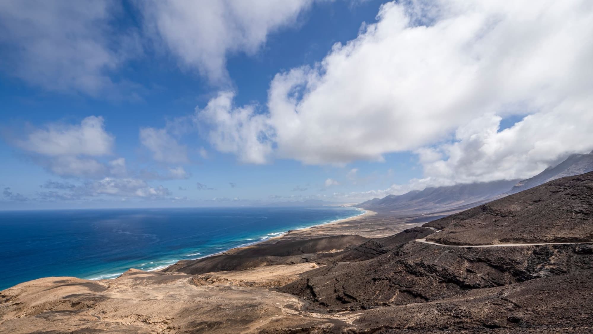 Stunning drone shot of the volcanic coast in Fuerteventura, showcasing dramatic landscapes.