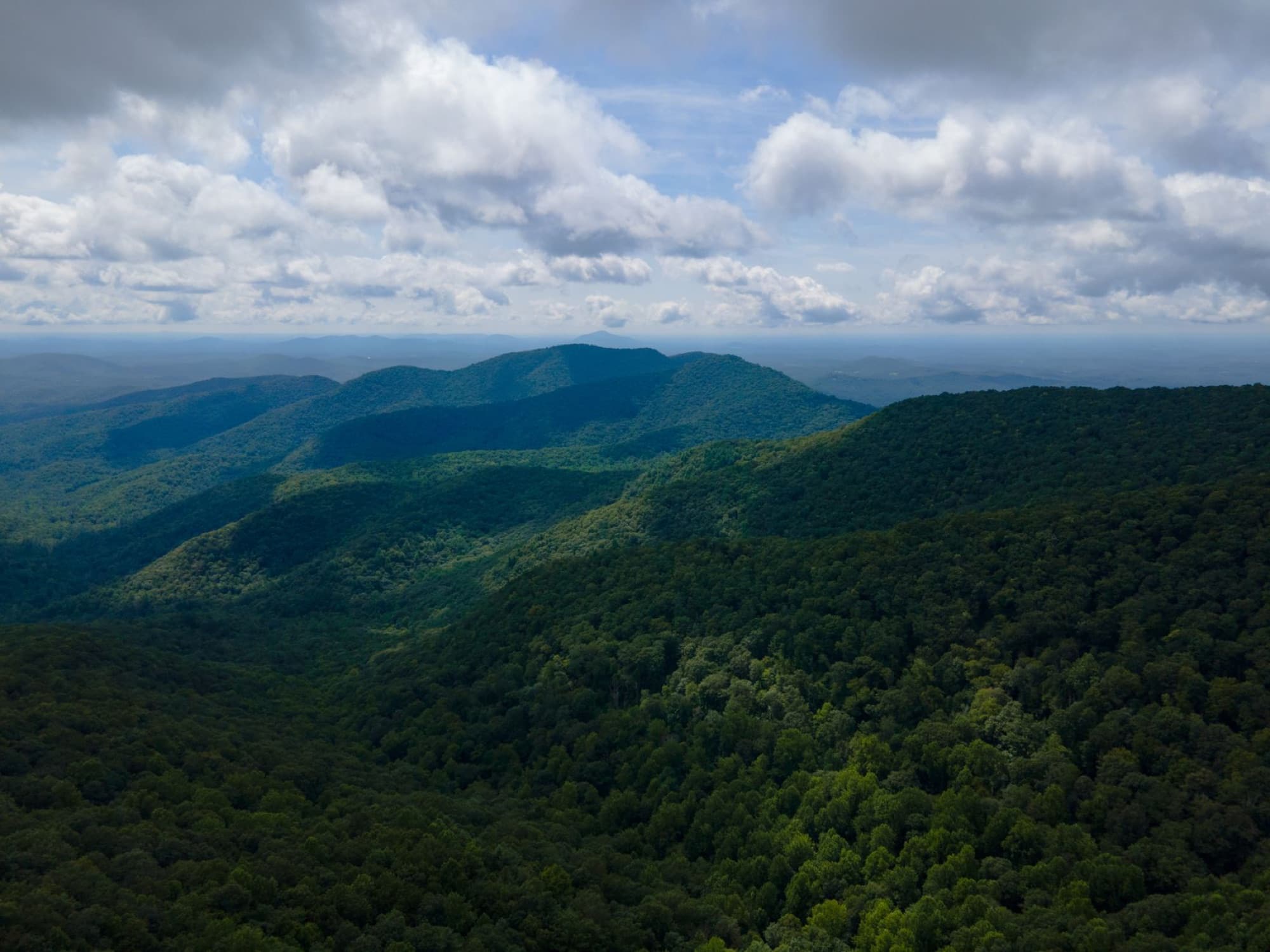 Majestic aerial view of the lush Blue Ridge Mountains under a cloudy sky in Georgia, USA.