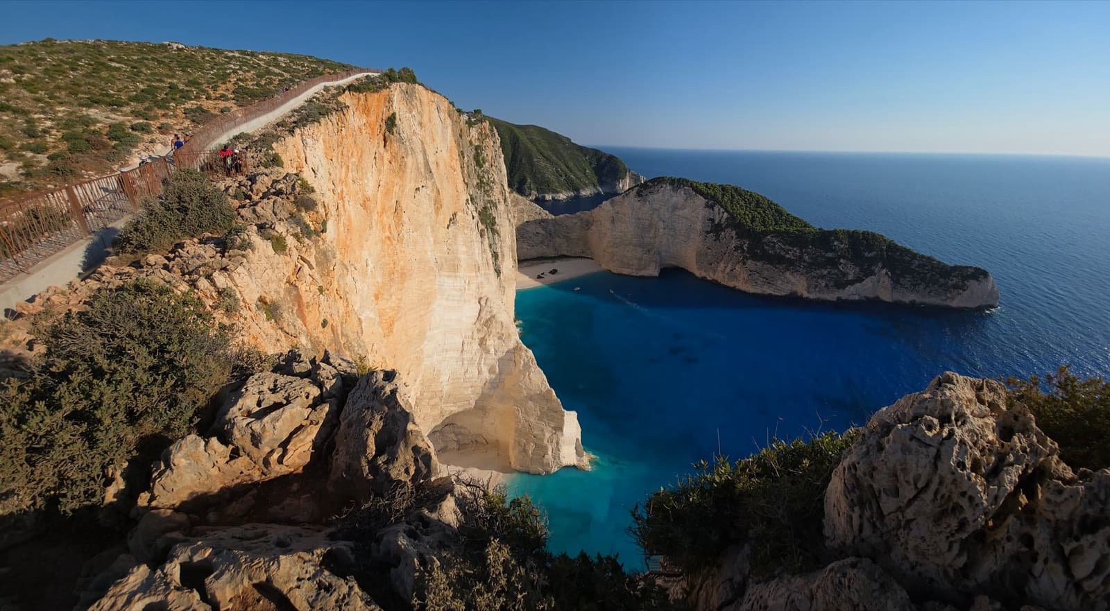 Stunning aerial view of Navagio Beach's cliffs and turquoise waters on Zakynthos Island, Greece.
