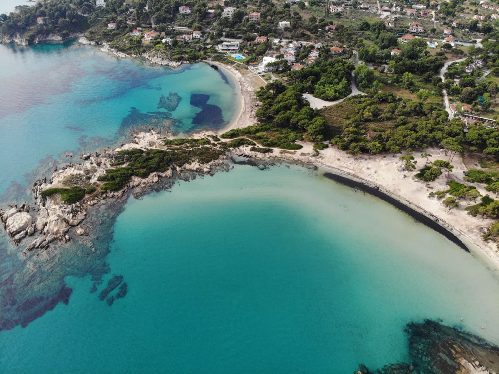 Discover the stunning beaches and vibrant sea of Sithonia, Halkidiki, Greece from above.