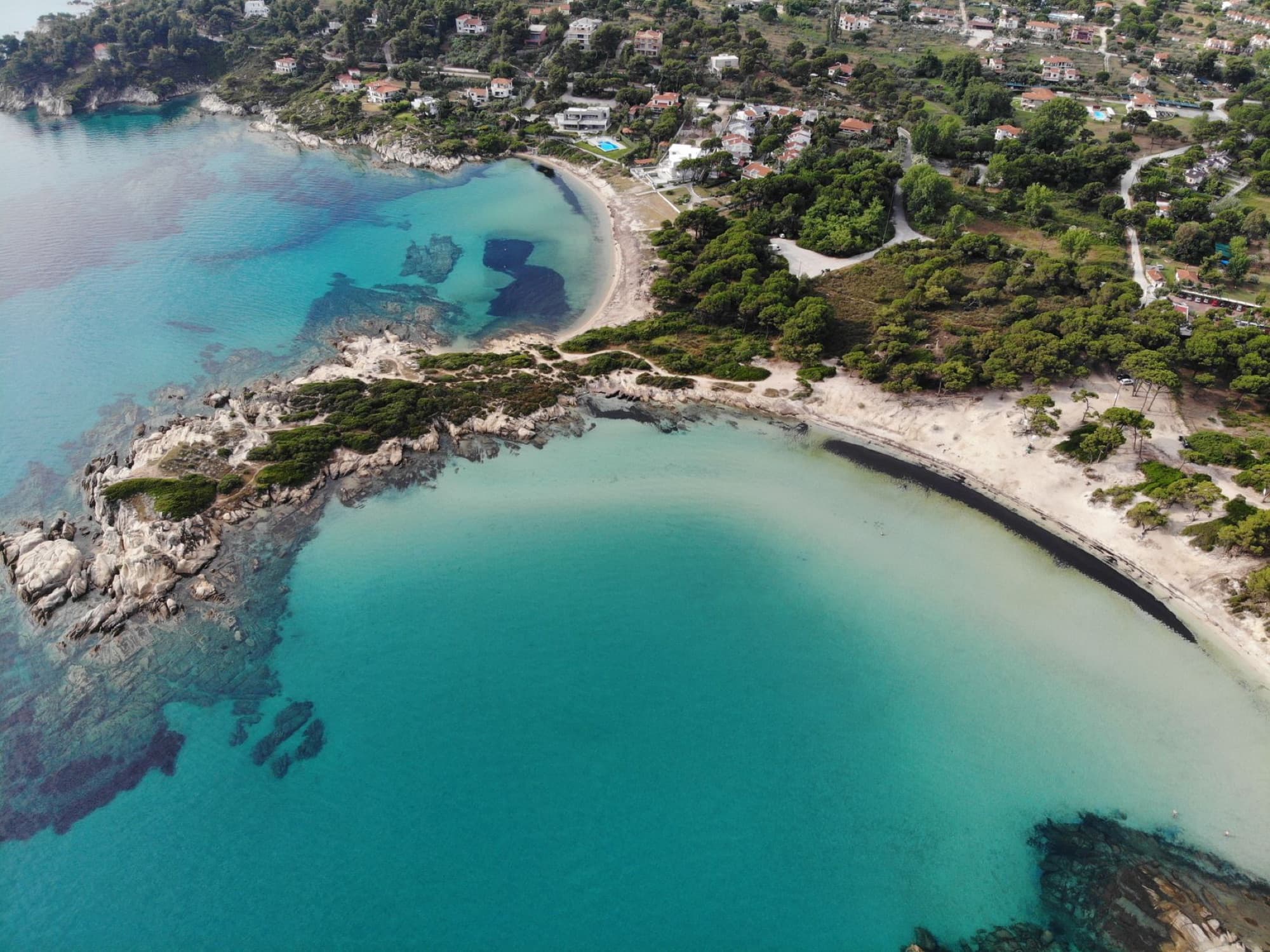 Discover the stunning beaches and vibrant sea of Sithonia, Halkidiki, Greece from above.