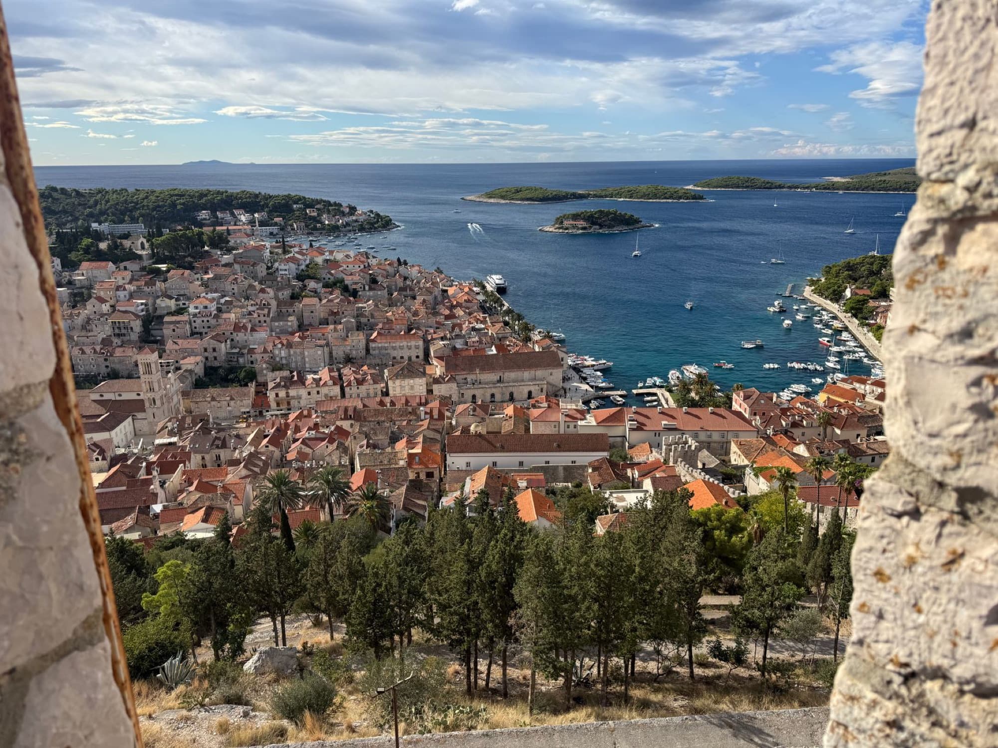Aerial view of Hvar Town overlooking the Adriatic Sea with islands and yachts.