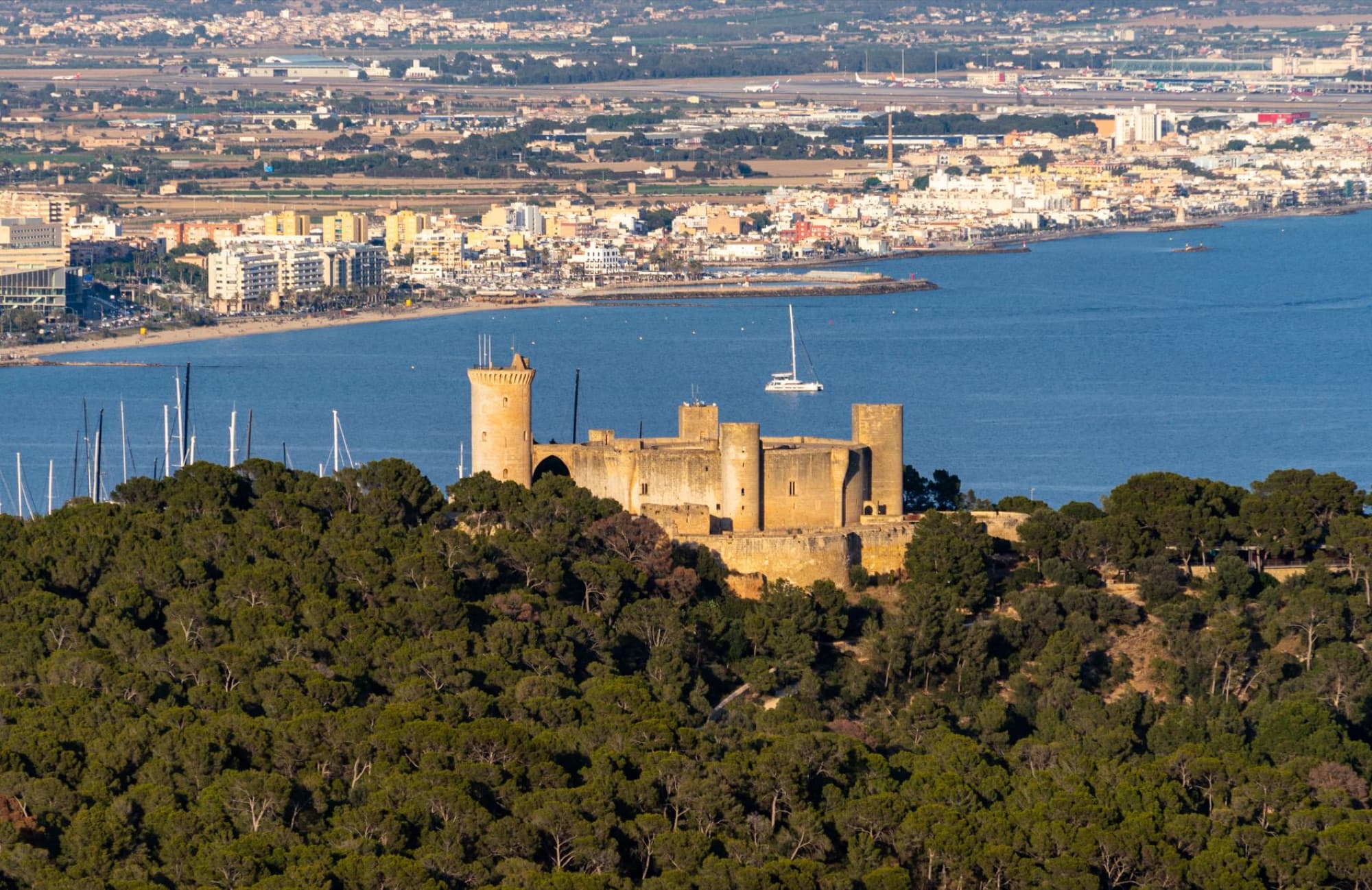 Aerial view of Bellver Castle overlooking the harbor and cityscape of Palma, Mallorca.